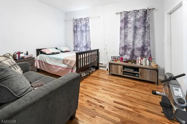 a bedroom with furniture and a wooden floor