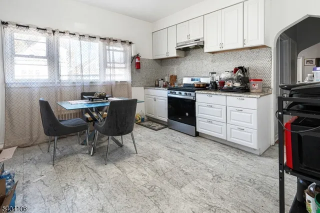 a kitchen with stainless steel appliances kitchen island granite countertop a sink and cabinets