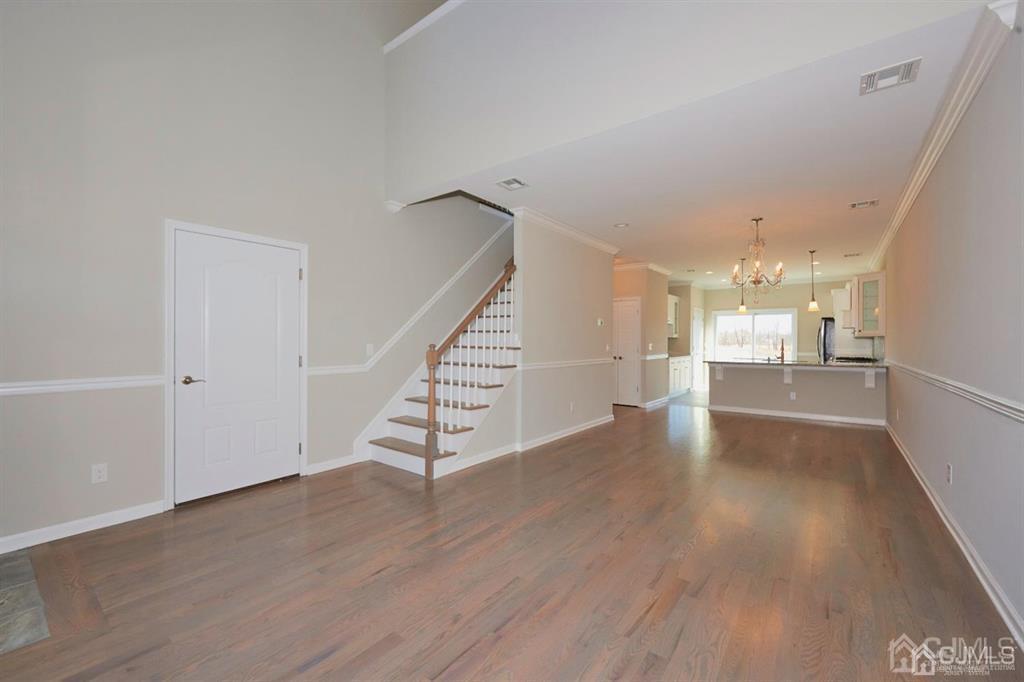 22 Green Tree Circle Hazlet, NJ 07730 - Photo 13 of 39 a view of a hallway with wooden floor and a kitchen