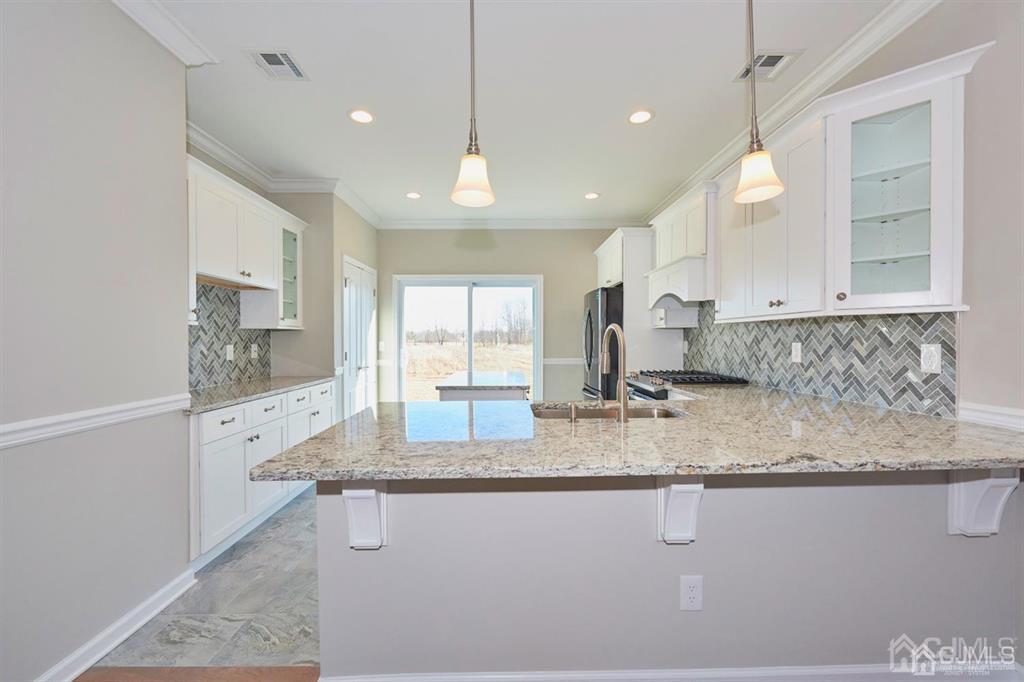22 Green Tree Circle Hazlet, NJ 07730 - Photo 2 of 39 a kitchen with stainless steel appliances granite countertop a sink stove and cabinets