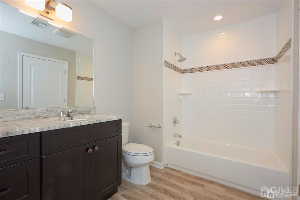 22 Green Tree Circle Hazlet, NJ 07730 - Photo 24 of 39 a bathroom with a granite countertop sink a toilet and shower