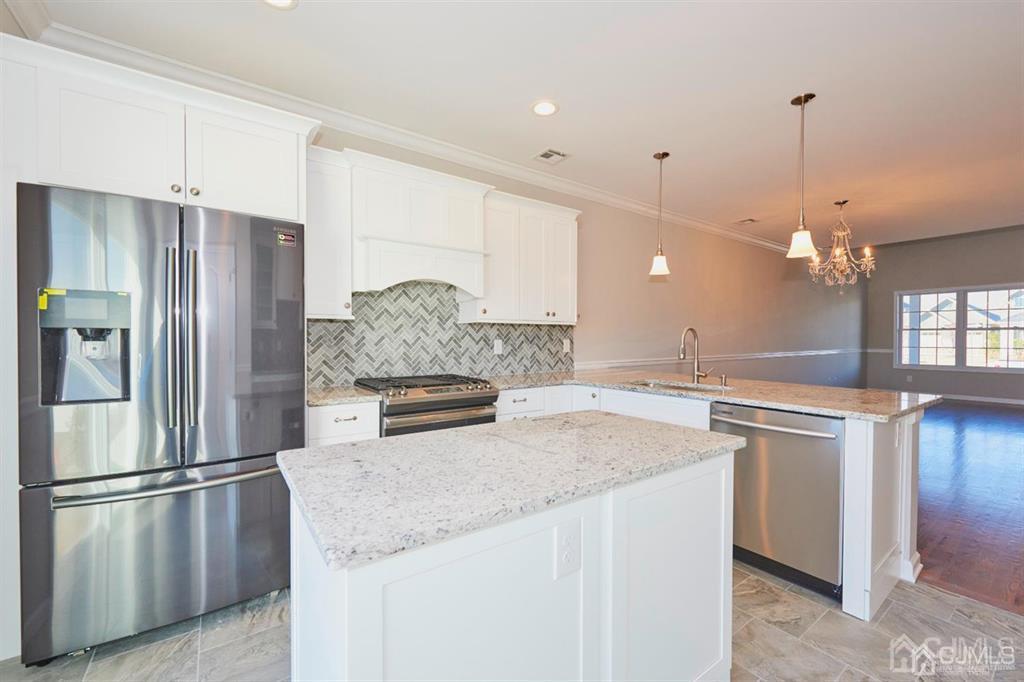 22 Green Tree Circle Hazlet, NJ 07730 - Photo 4 of 39 a kitchen with stainless steel appliances granite countertop a refrigerator a sink a stove and a refrigerator