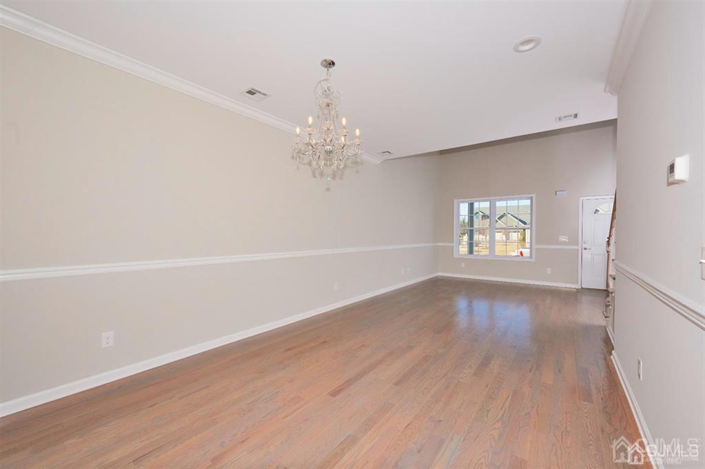 22 Green Tree Circle Hazlet, NJ 07730 - Photo 9 of 39 wooden floor in an empty room with a window
