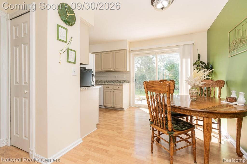 67976 Van Dyke Road, Unit 15 Washington, MI 48095 - Photo 16 of 35 Wood-finish flooring throughout, sliding glass door, recessed lighting, and perimeter kitchen cabinetry