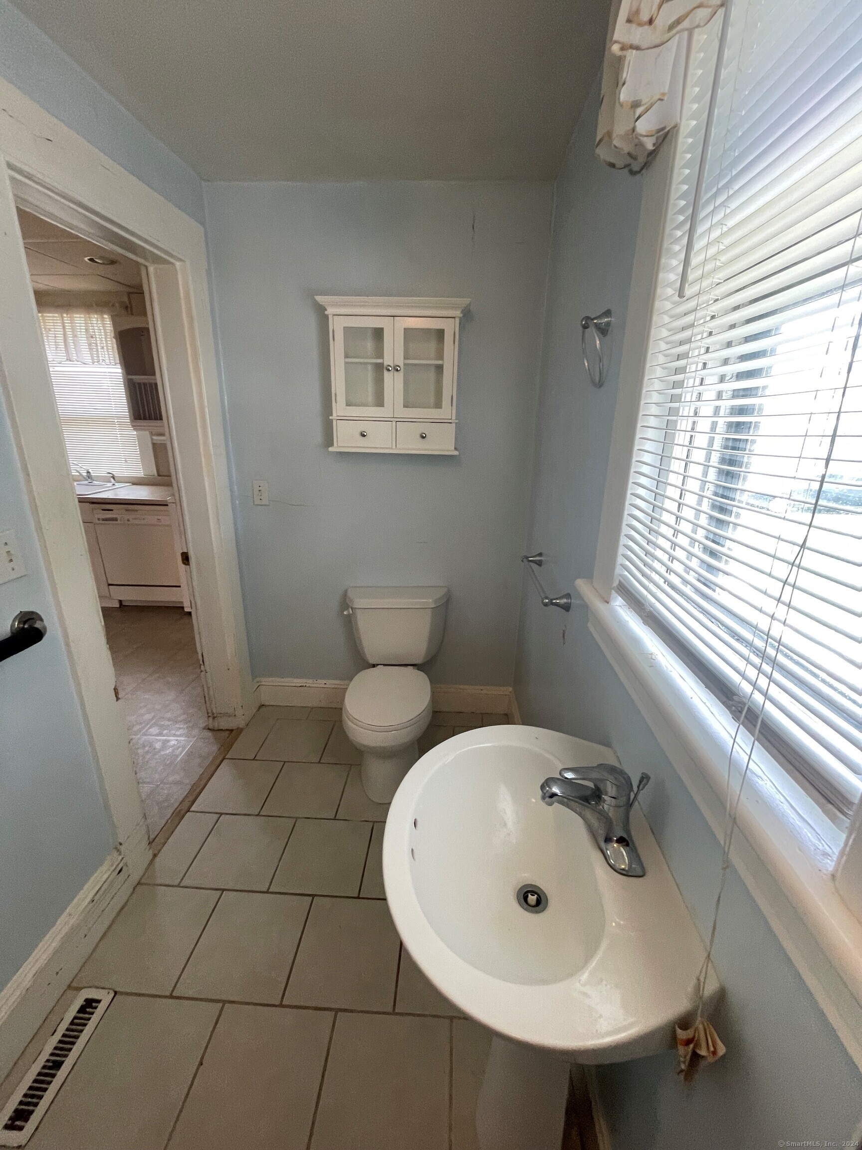 22 Fairview Street Milford, CT 06460 - Photo 11 of 28 a bathroom with a sink a toilet and mirror