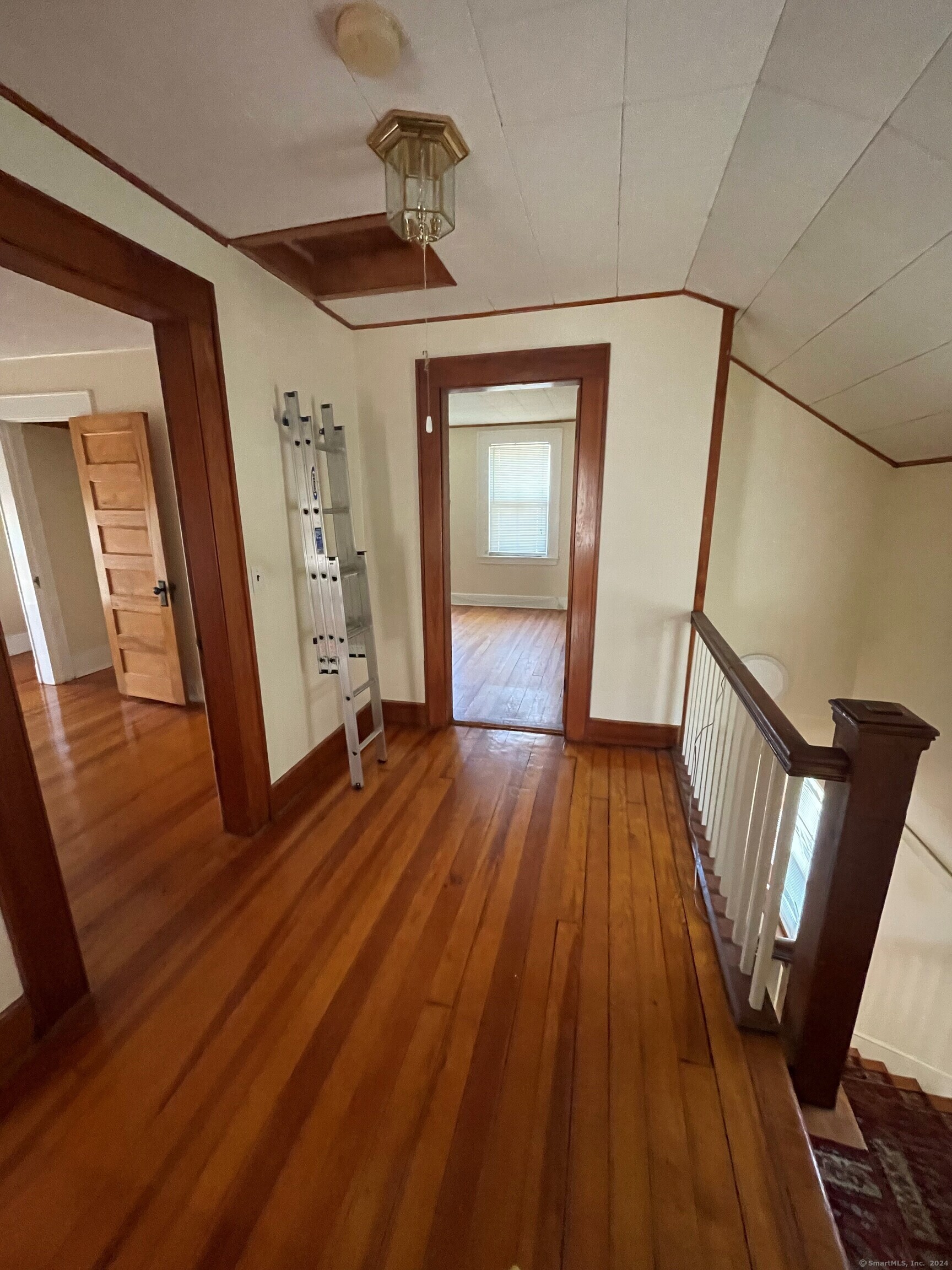22 Fairview Street Milford, CT 06460 - Photo 13 of 28 a view of a hallway with wooden floor and staircase
