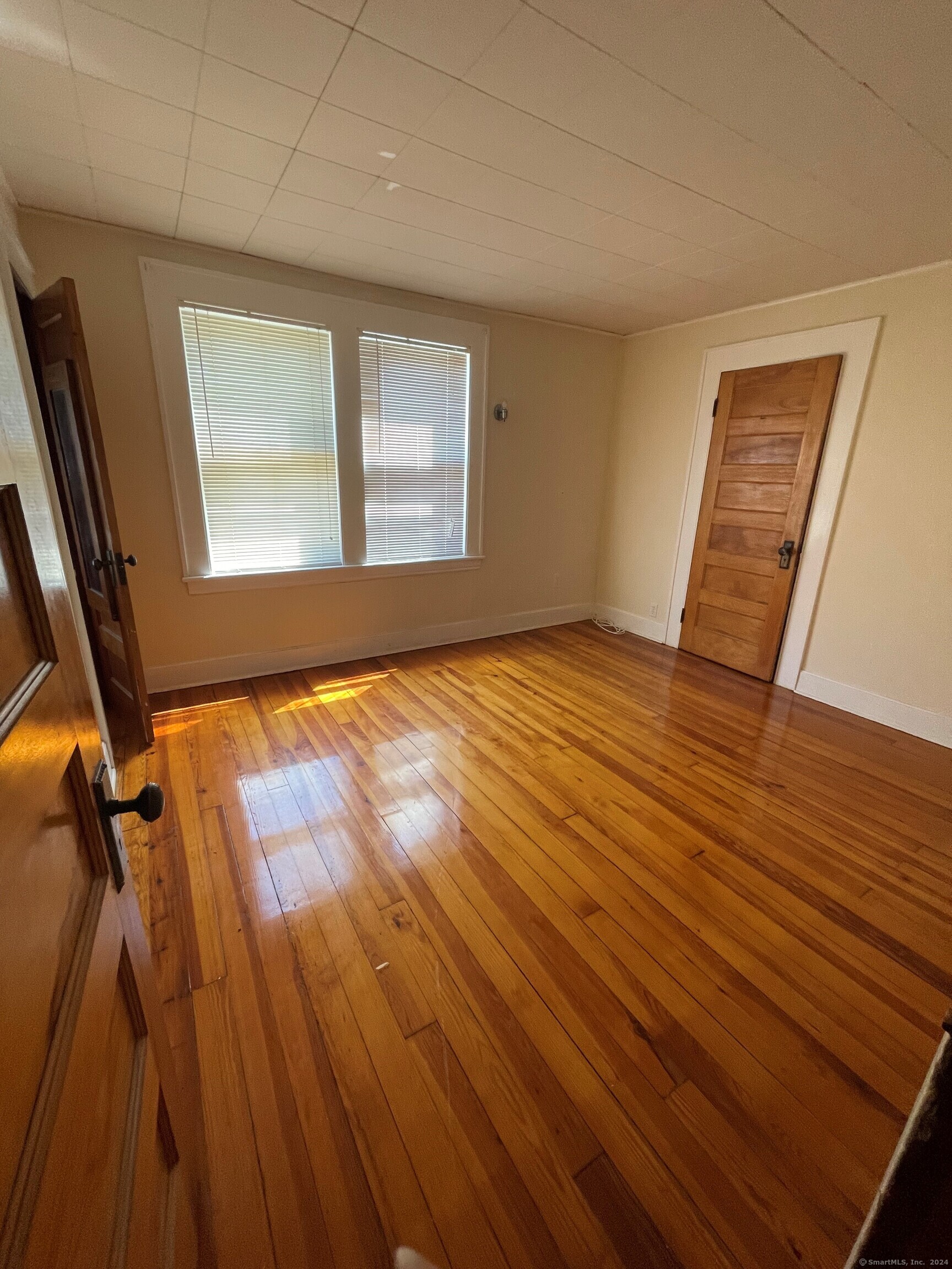 22 Fairview Street Milford, CT 06460 - Photo 14 of 28 a view of an empty room with wooden floor and a window