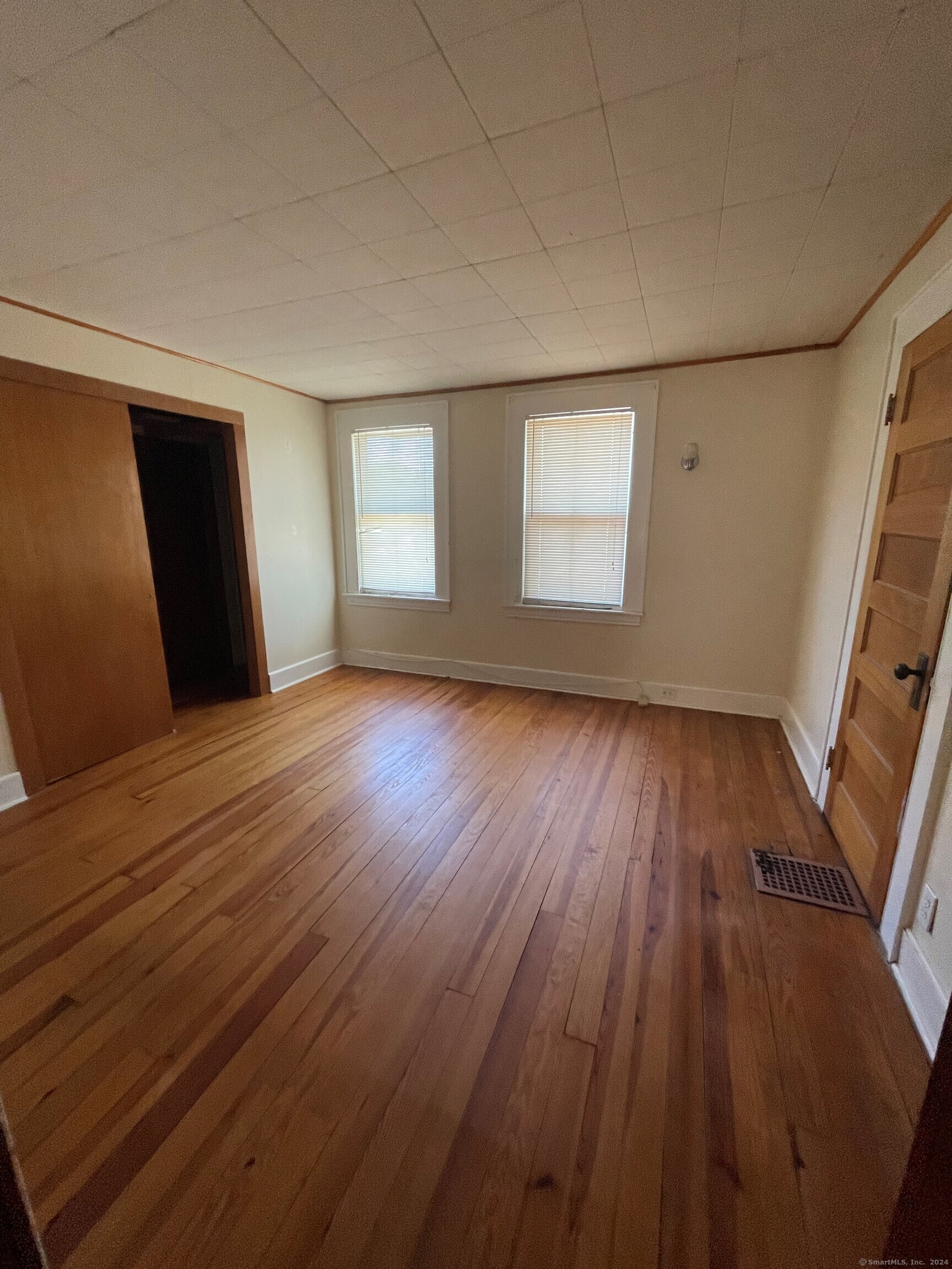 22 Fairview Street Milford, CT 06460 - Photo 16 of 28 an empty room with wooden floor and windows