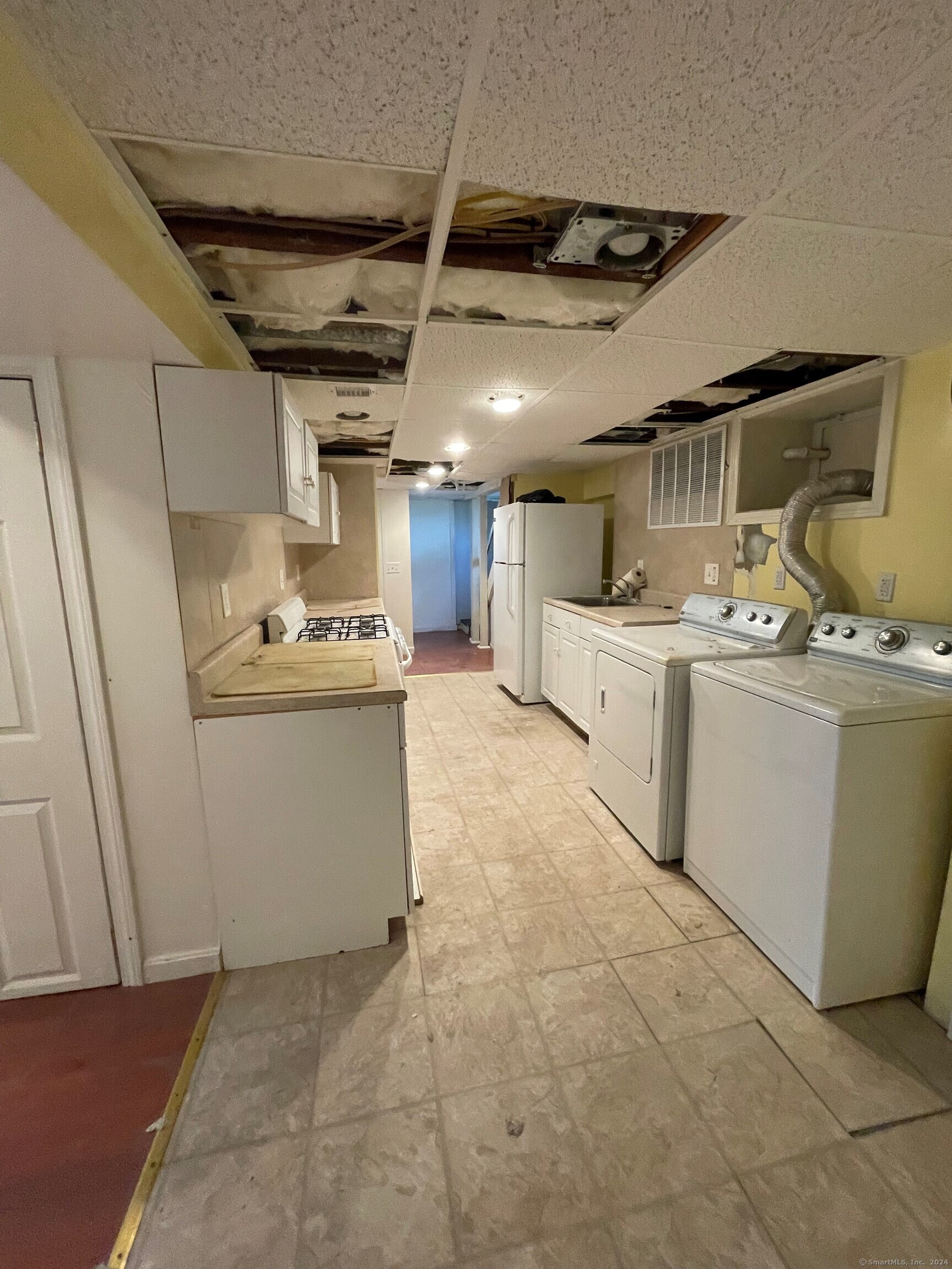 22 Fairview Street Milford, CT 06460 - Photo 21 of 28 a utility room with cabinets dryer and washer
