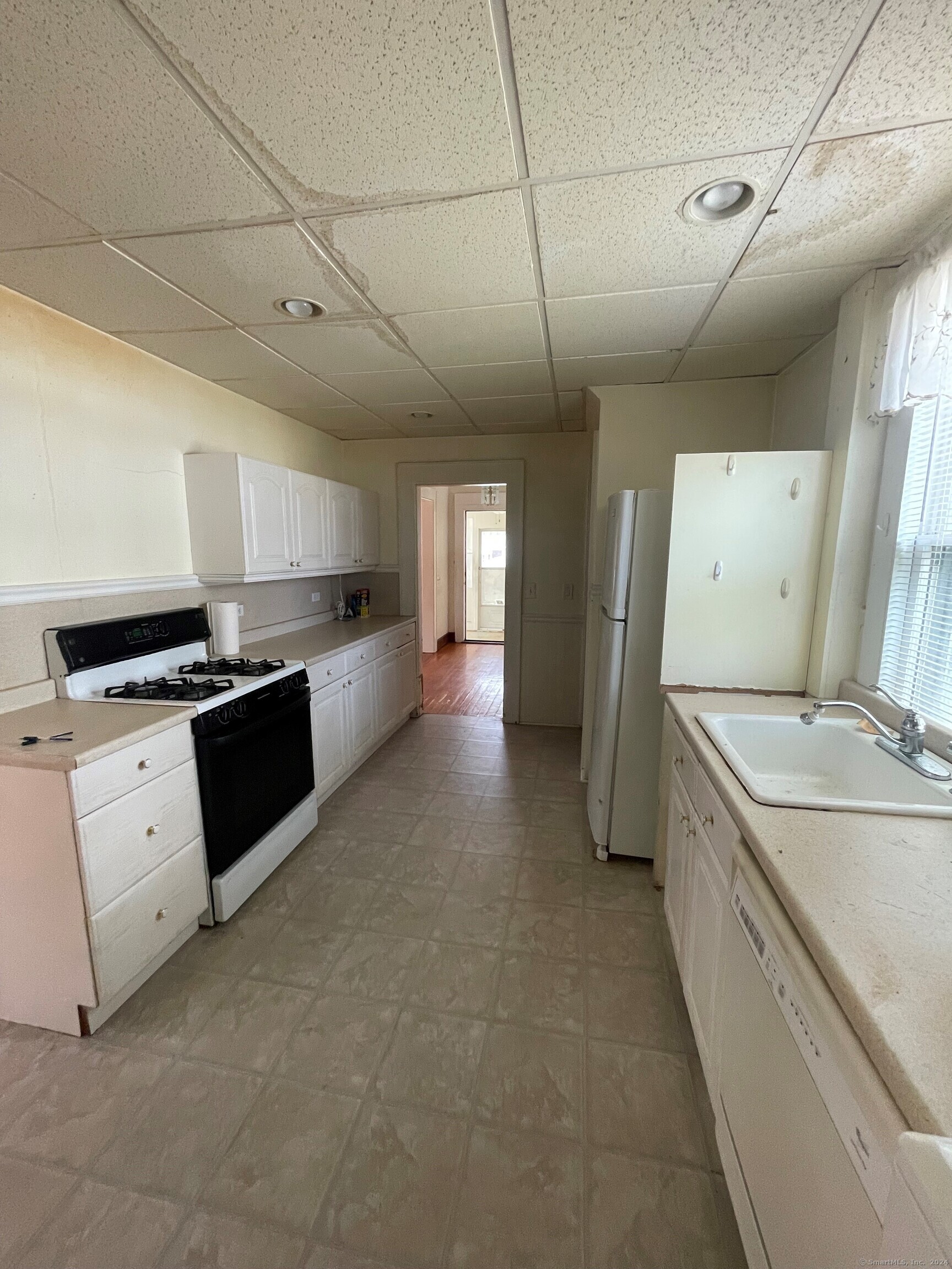 22 Fairview Street Milford, CT 06460 - Photo 22 of 28 a large white kitchen with a stove top oven