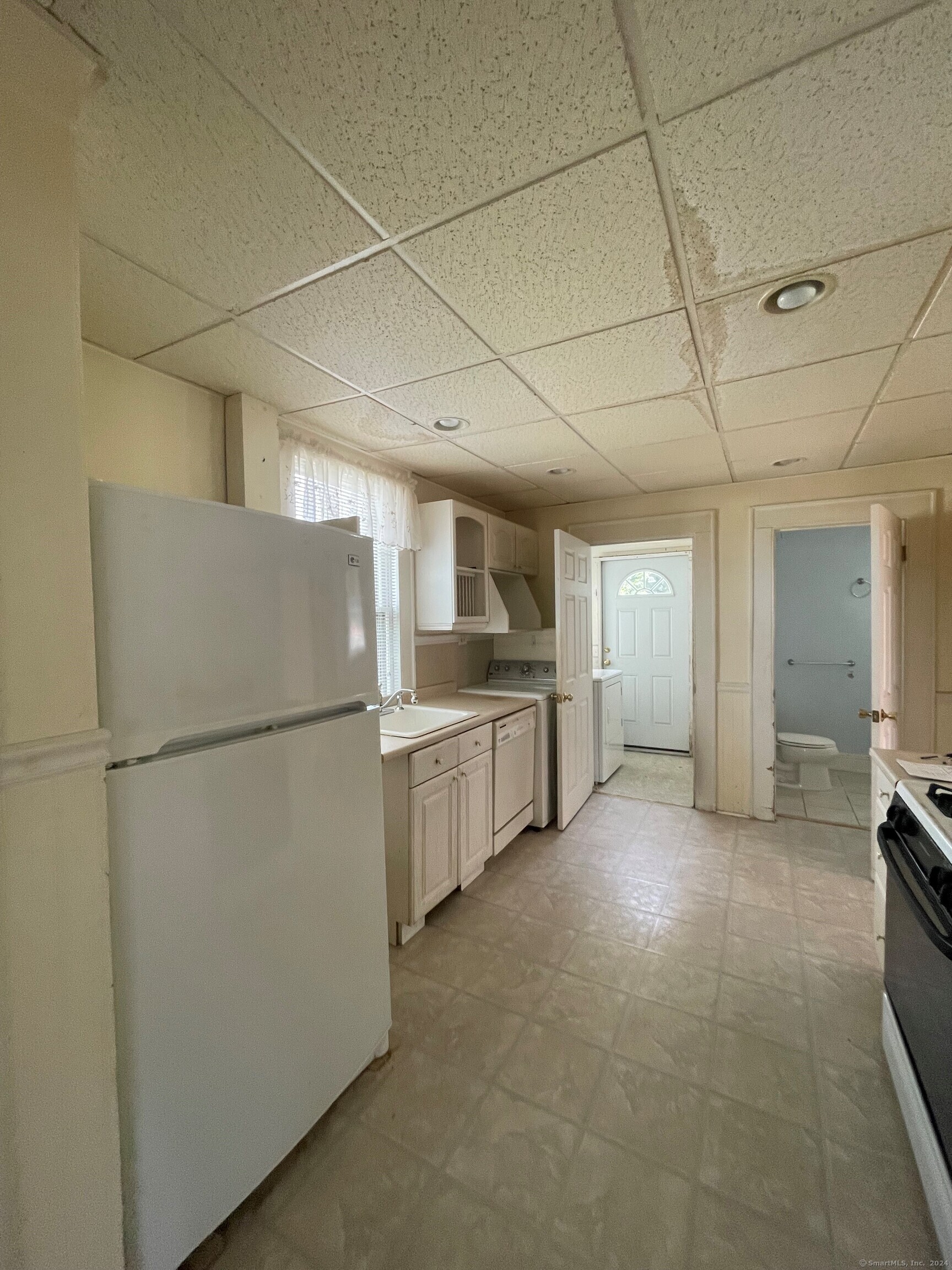 22 Fairview Street Milford, CT 06460 - Photo 23 of 28 a view of a kitchen with a refrigerator and a sink