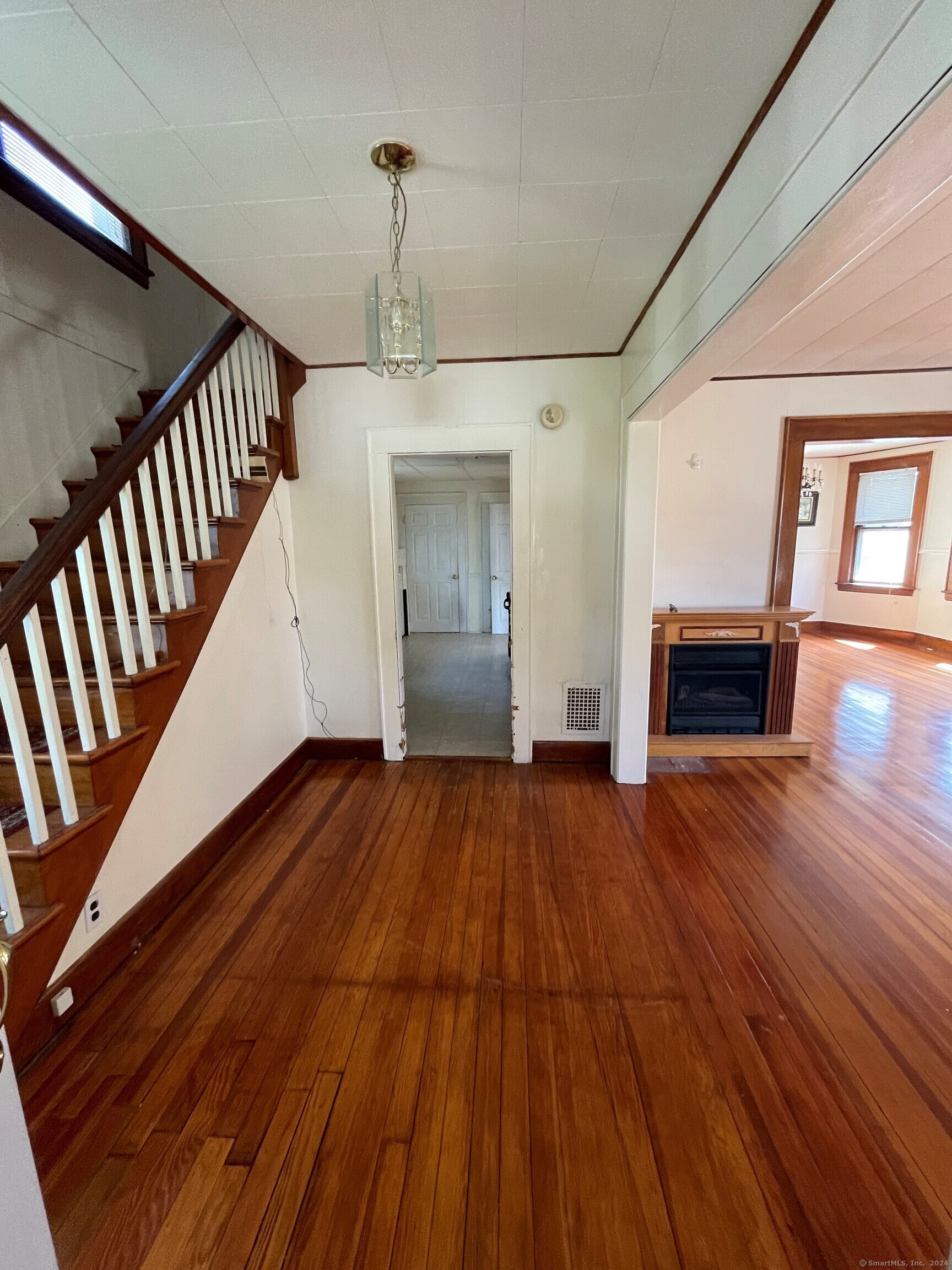 22 Fairview Street Milford, CT 06460 - Photo 3 of 28 a view of empty room with wooden floor and window