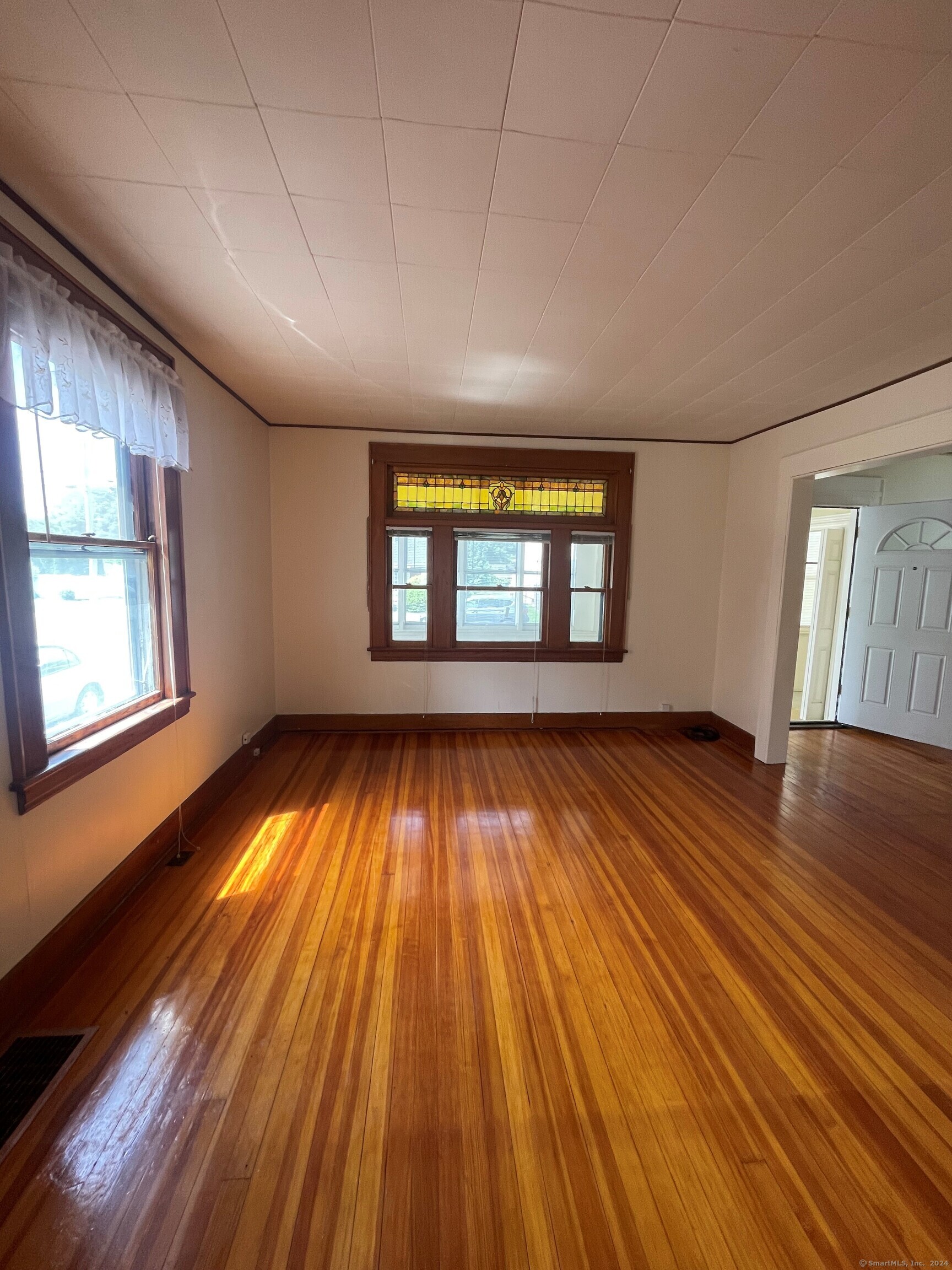22 Fairview Street Milford, CT 06460 - Photo 5 of 28 wooden floor in an empty room with a window