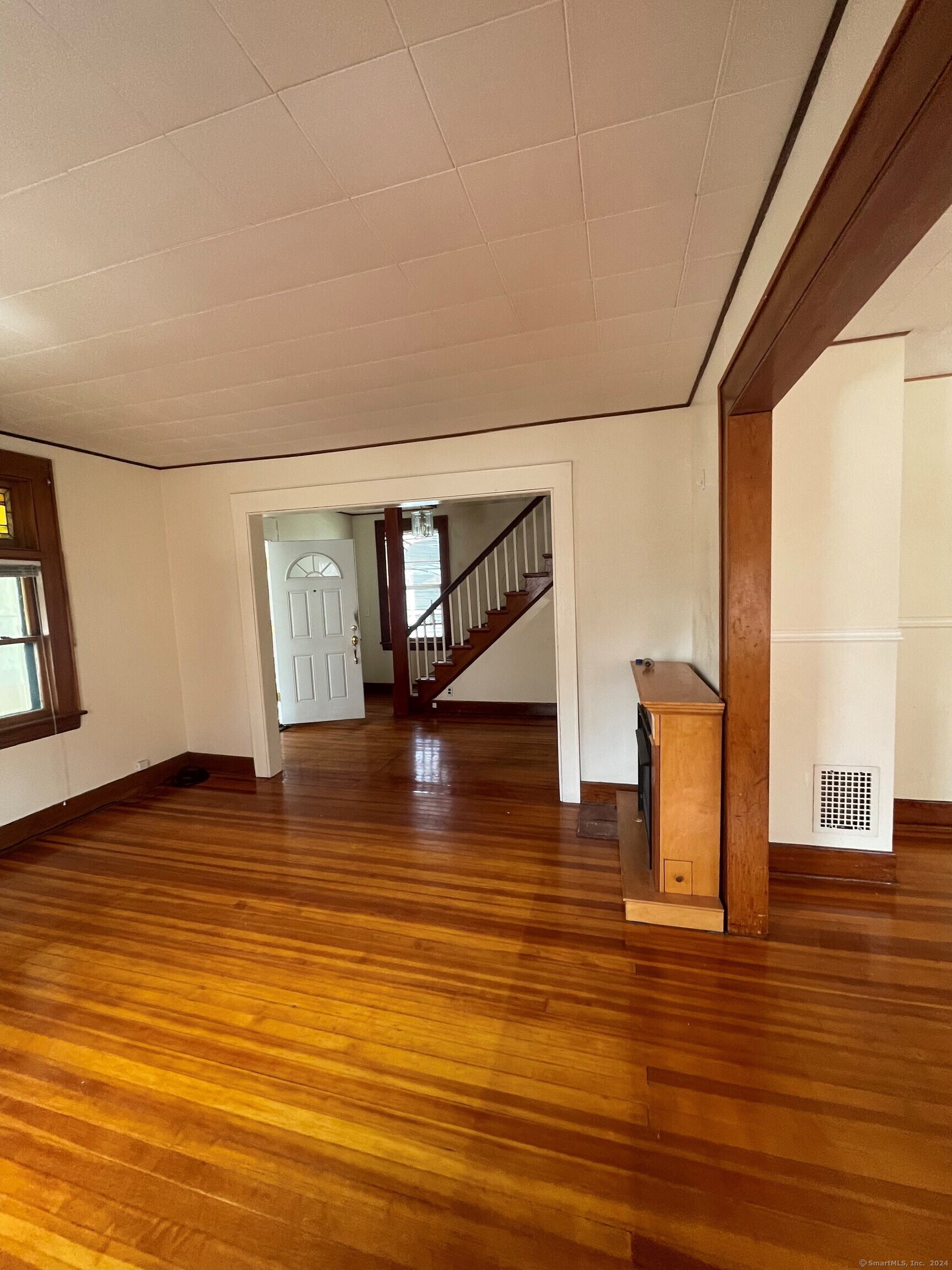 22 Fairview Street Milford, CT 06460 - Photo 6 of 28 a view of empty room with wooden floor