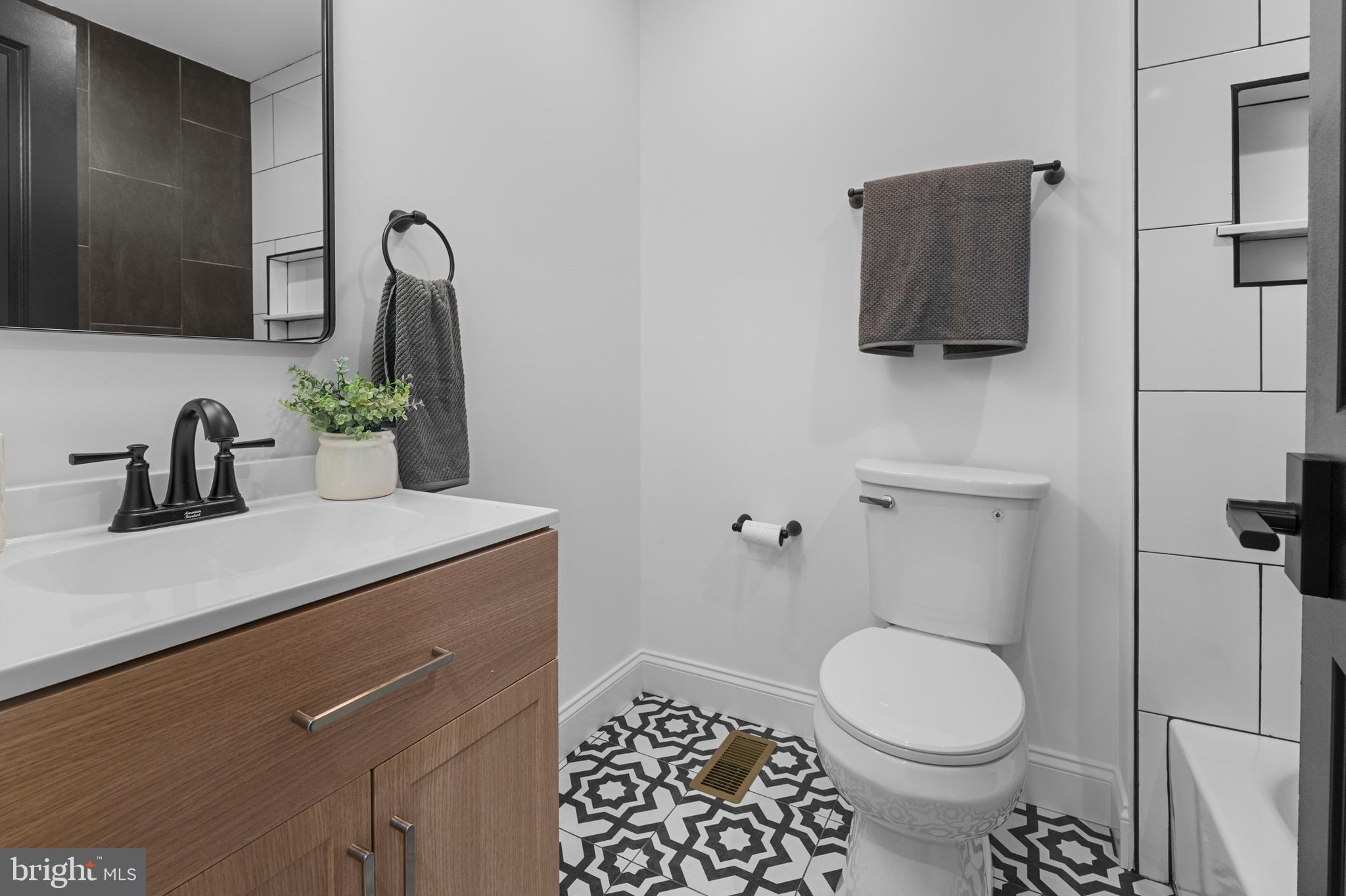 2516 Federal Street Baltimore, MD 21213 - Photo 20 of 40 a bathroom with a toilet sink and mirror