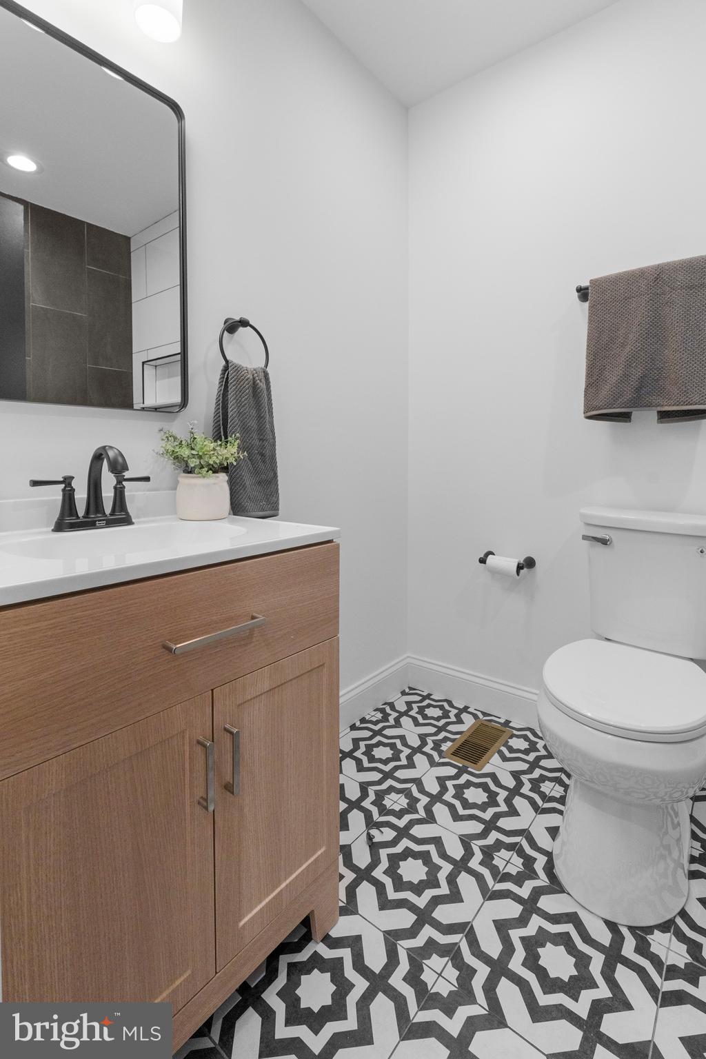 2516 Federal Street Baltimore, MD 21213 - Photo 21 of 40 a bathroom with a sink toilet and mirror