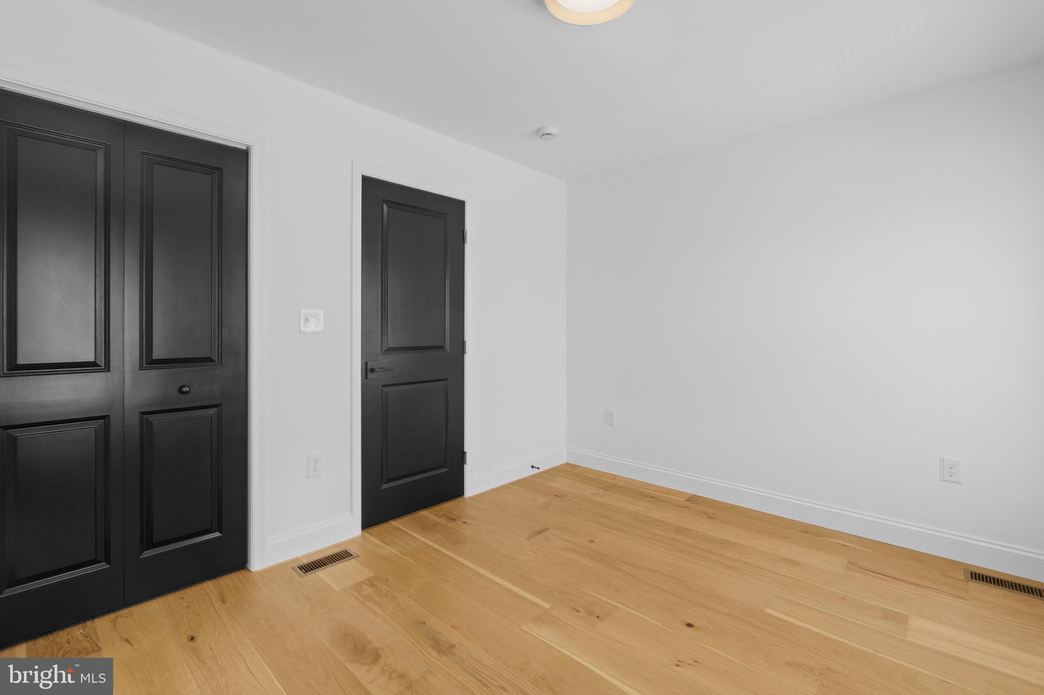 2516 Federal Street Baltimore, MD 21213 - Photo 25 of 40 a bedroom with a bed and wooden floor