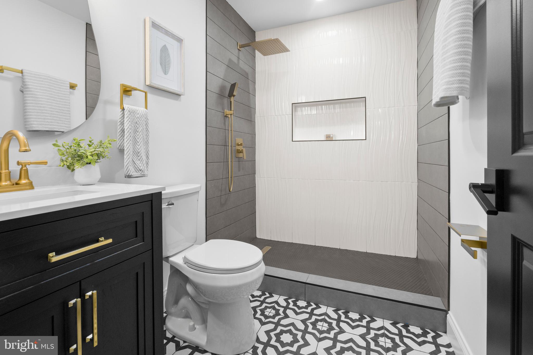 2516 Federal Street Baltimore, MD 21213 - Photo 6 of 40 a bathroom with a sink a toilet and shower