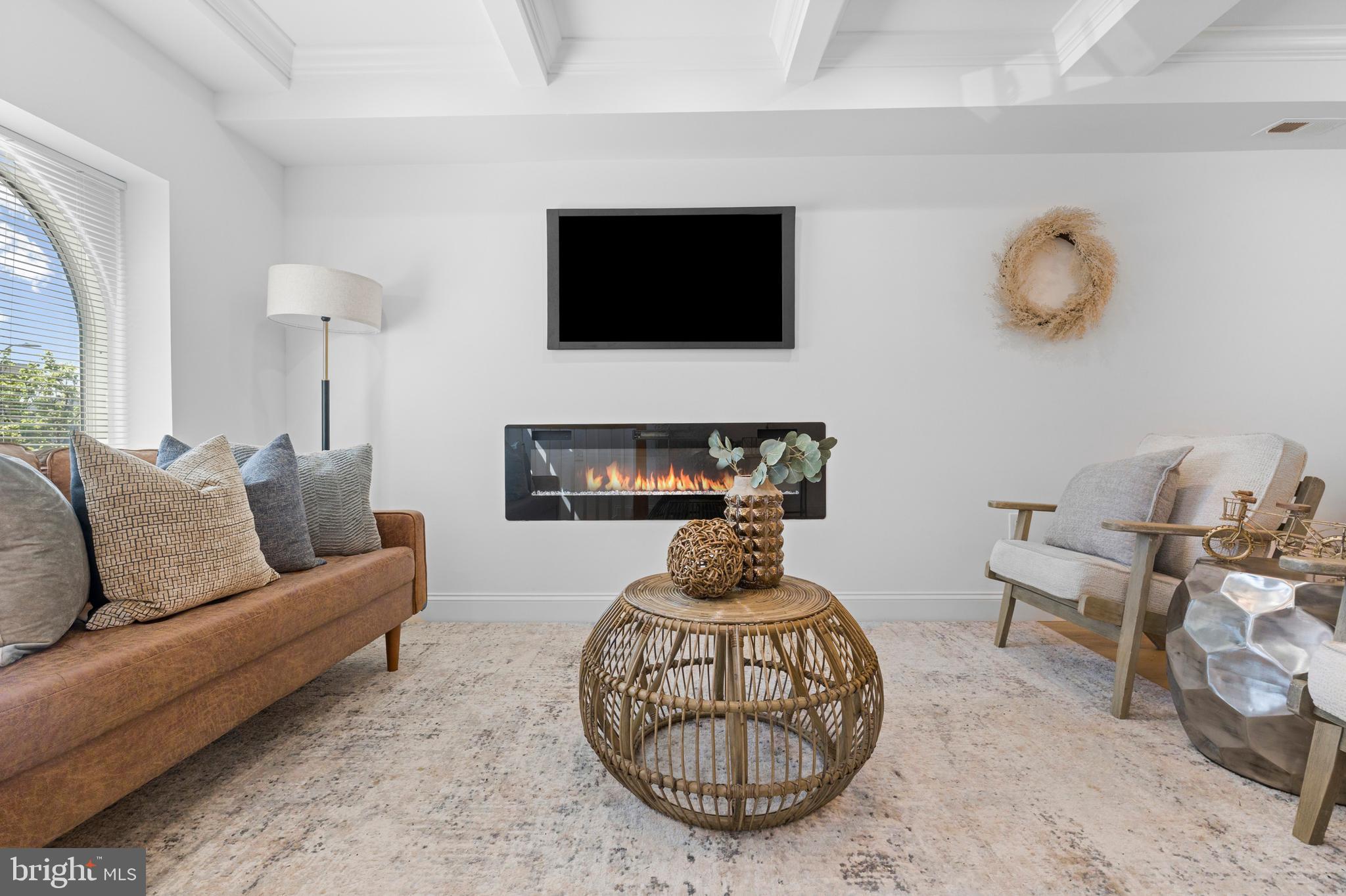 2516 Federal Street Baltimore, MD 21213 - Photo 10 of 40 a living room with furniture a flat screen tv and a fireplace