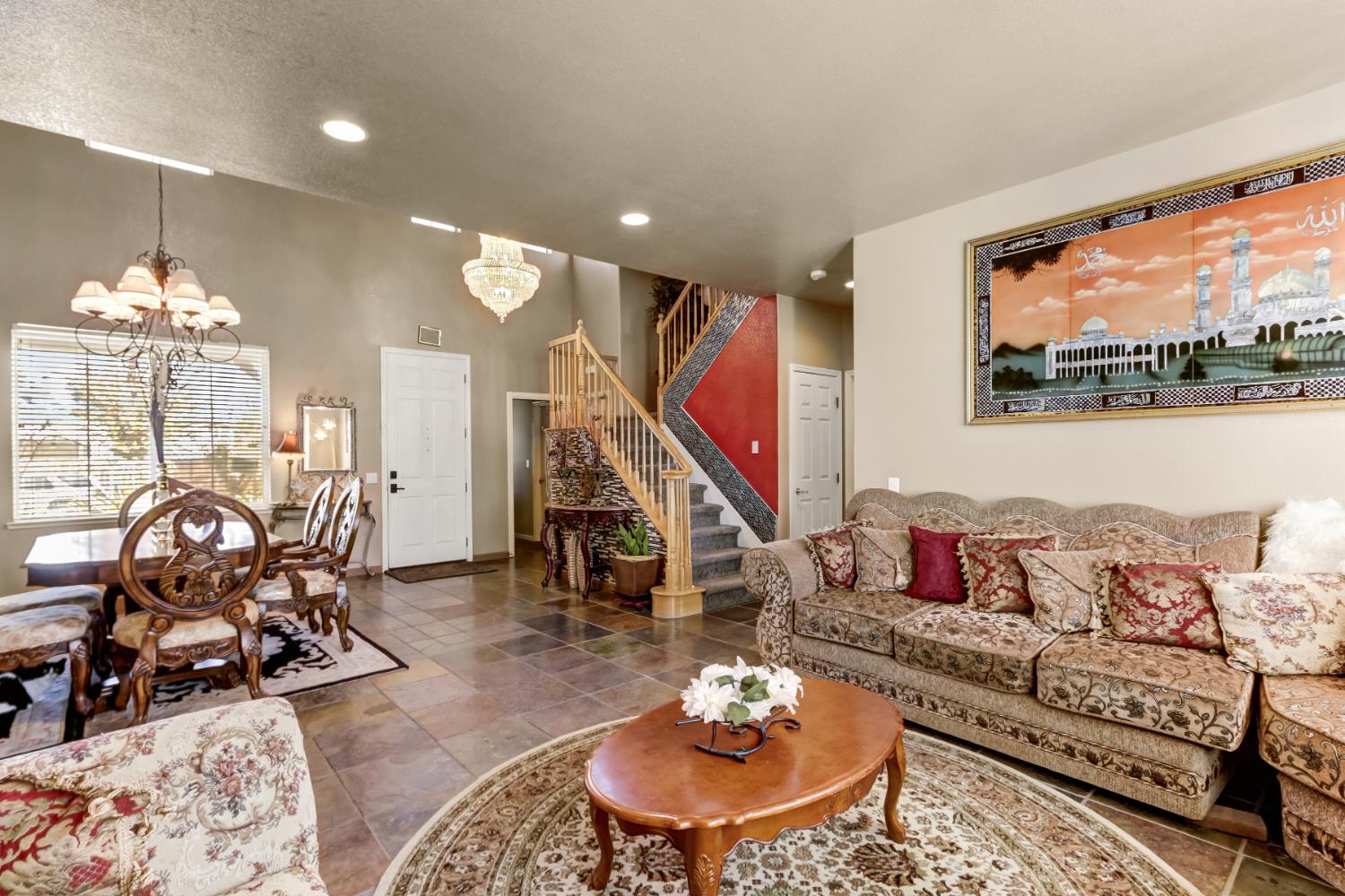 9820 Spring View Way Elk Grove, CA 95757 - Photo 11 of 49 a living room with furniture a rug and a chandelier