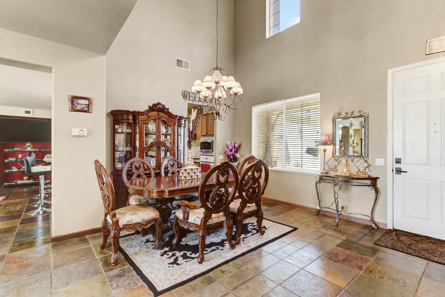 9820 Spring View Way Elk Grove, CA 95757 - Photo 13 of 49 a view of a dining room with furniture and chandelier