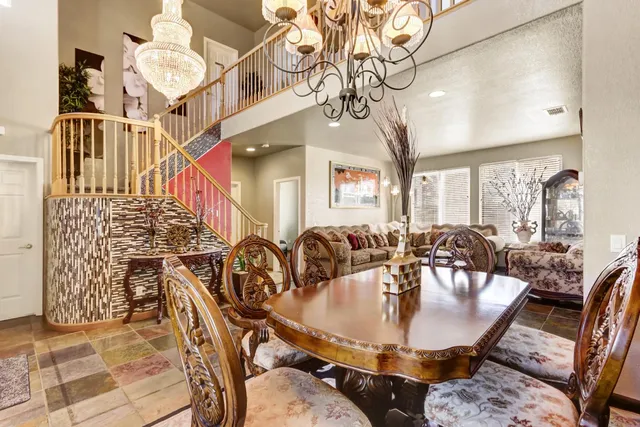 a view of a dining room with furniture and chandelier