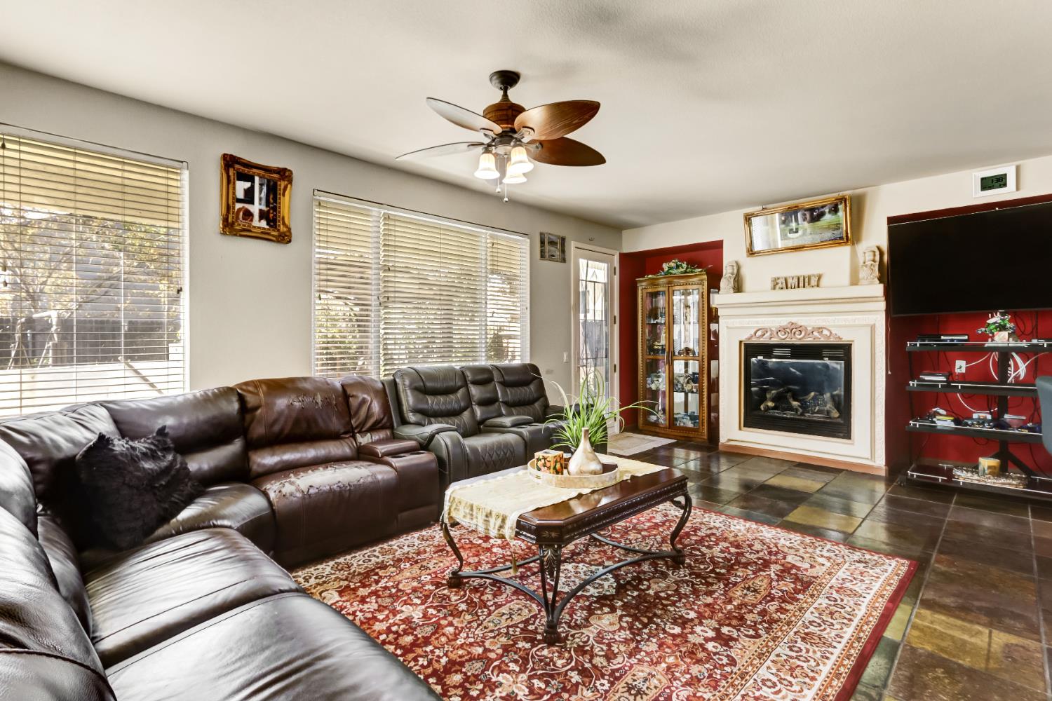 9820 Spring View Way Elk Grove, CA 95757 - Photo 16 of 49 a living room with furniture a flat screen tv and a fireplace