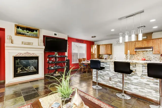 a living room with fireplace furniture and a flat screen tv
