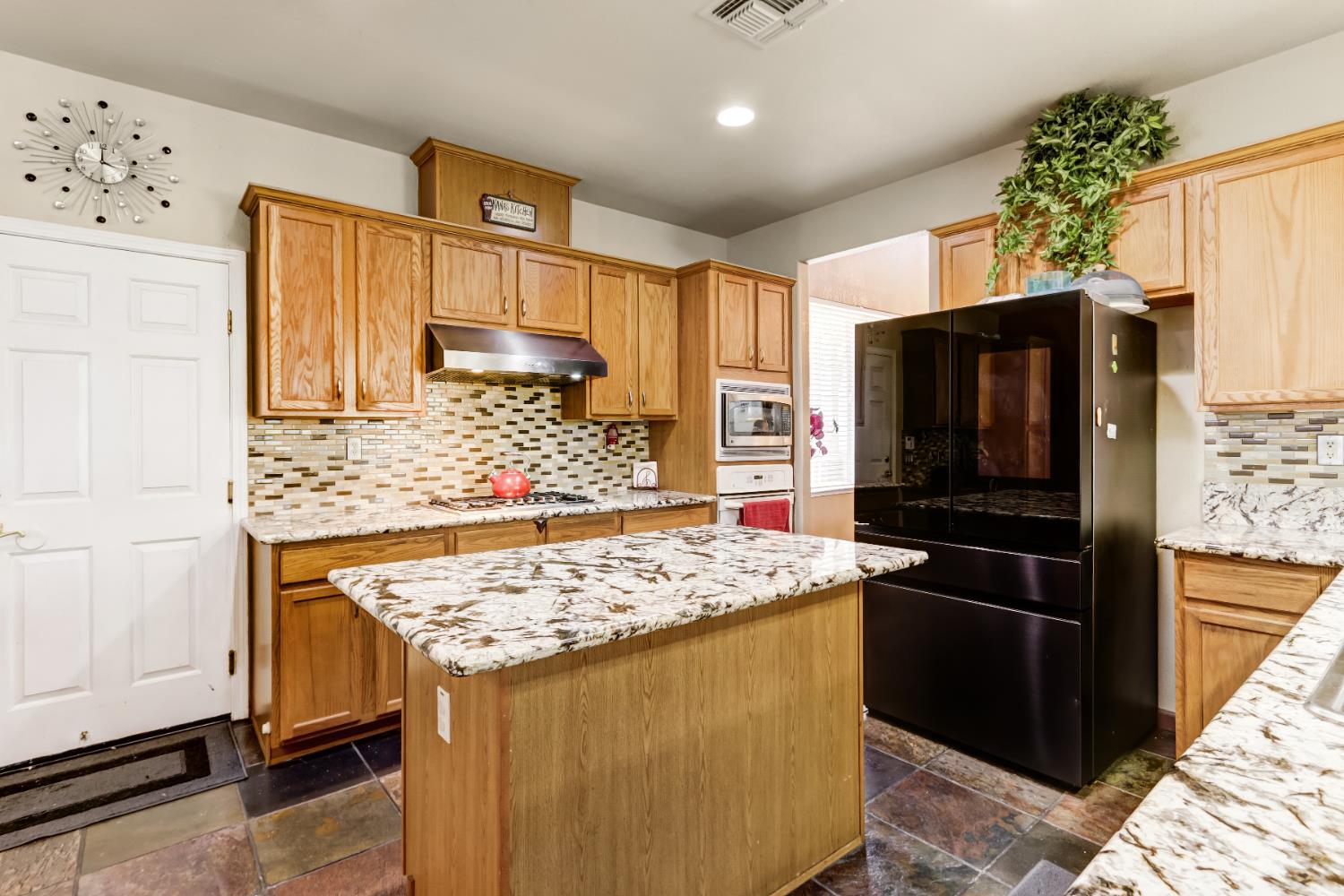 9820 Spring View Way Elk Grove, CA 95757 - Photo 18 of 49 a kitchen with stainless steel appliances granite countertop a stove refrigerator and cabinets