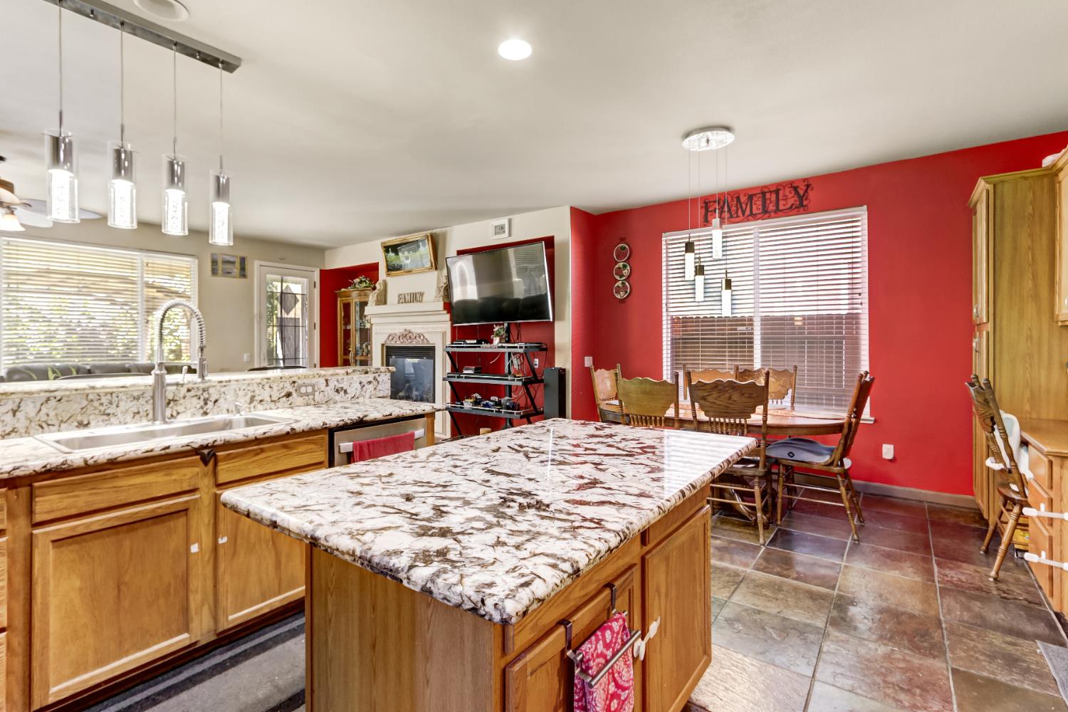 9820 Spring View Way Elk Grove, CA 95757 - Photo 21 of 49 a kitchen with kitchen island granite countertop wooden cabinets and granite counter tops