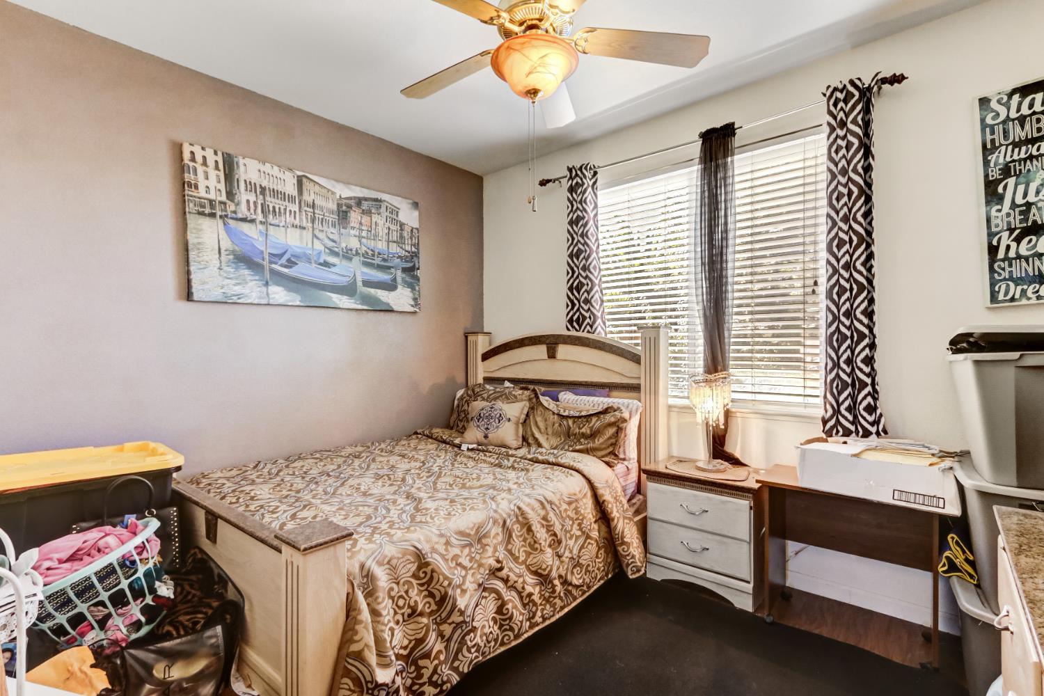 9820 Spring View Way Elk Grove, CA 95757 - Photo 38 of 49 a bedroom with a bed and a chandelier