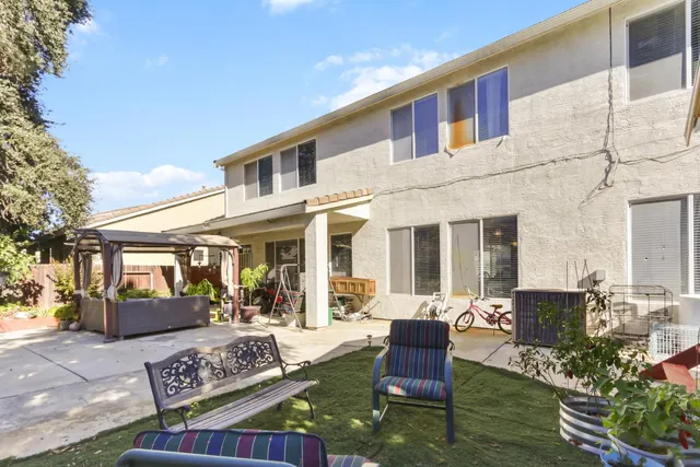 a front view of a house with outdoor seating