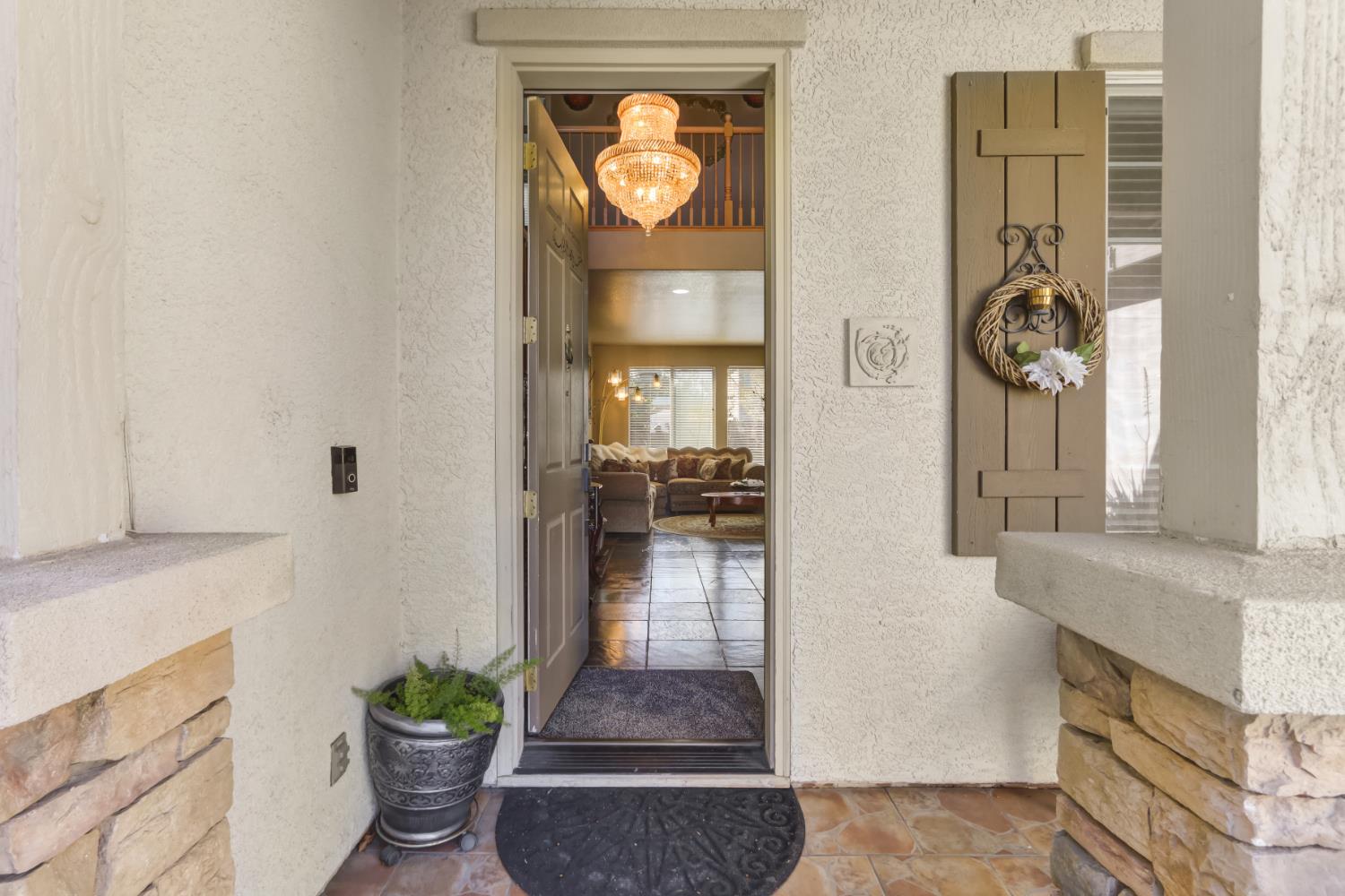 9820 Spring View Way Elk Grove, CA 95757 - Photo 6 of 49 a hallway with dining area and chandelier