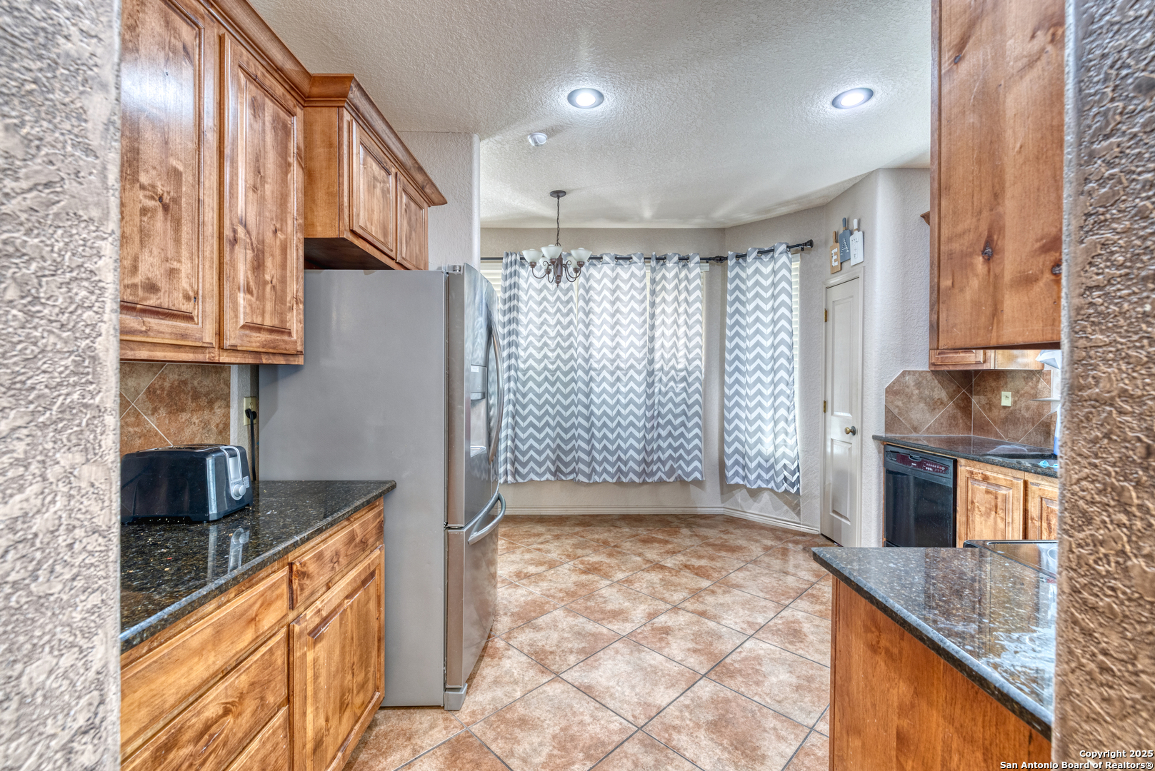3 Briar Court Uvalde, TX 78801 - Photo 14 of 27 a kitchen with stainless steel appliances granite countertop a stove a sink and a refrigerator