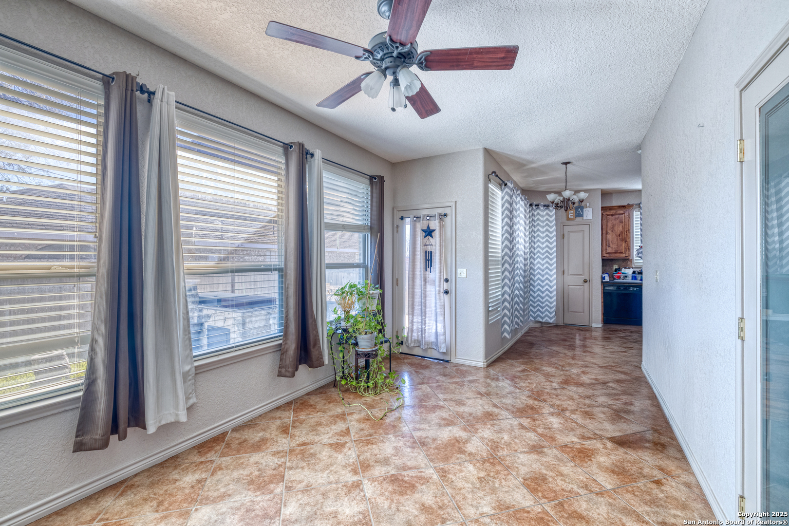 3 Briar Court Uvalde, TX 78801 - Photo 18 of 27 a view of a big room with windows and chandelier fan