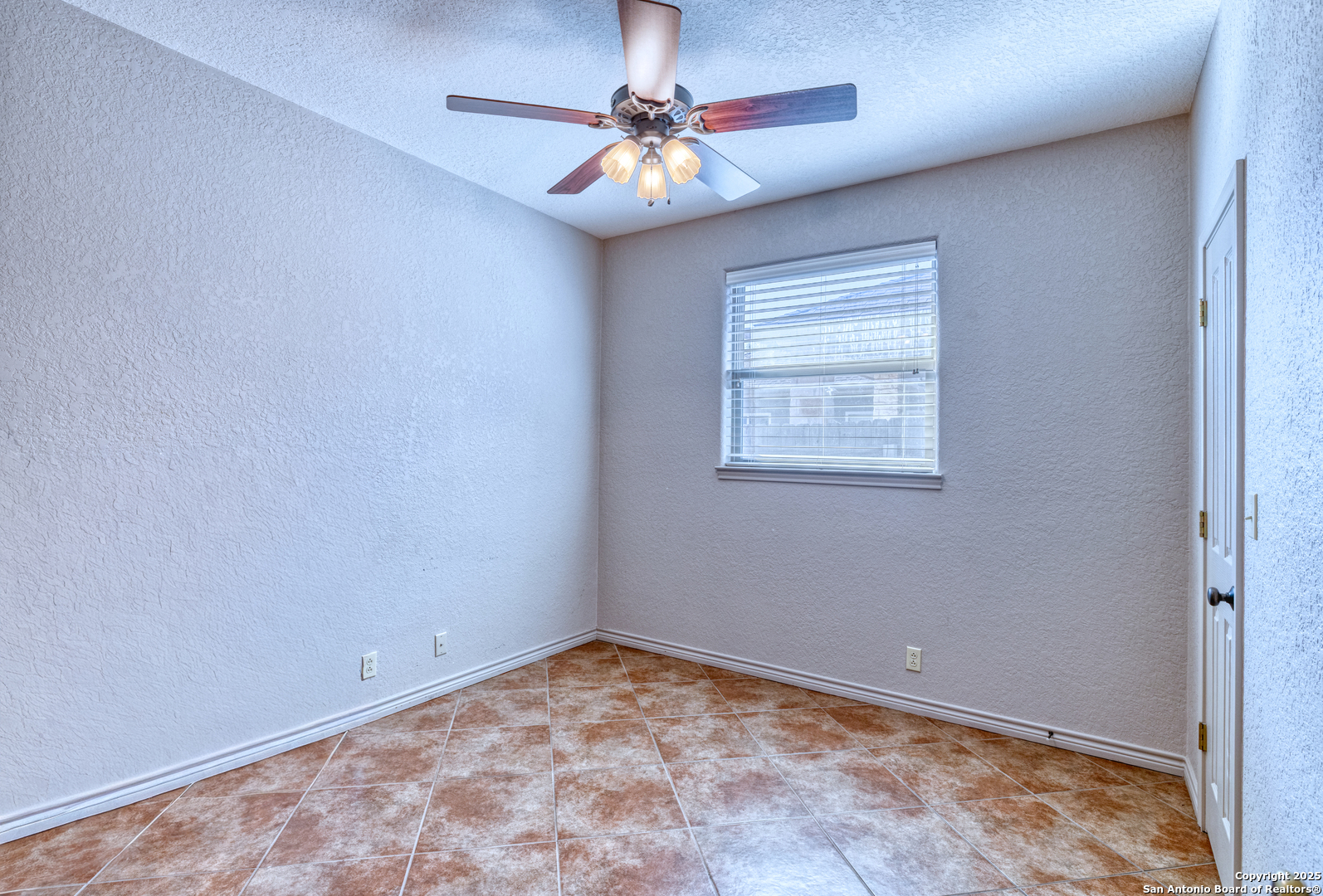 3 Briar Court Uvalde, TX 78801 - Photo 21 of 27 a view of a room with a ceiling fan and a window