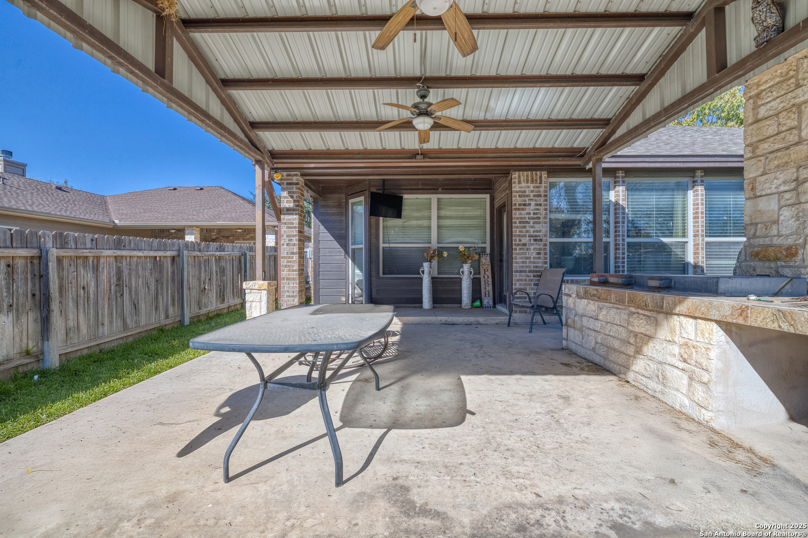 3 Briar Court Uvalde, TX 78801 - Photo 6 of 27 a view of a backyard with a patio and wooden fence
