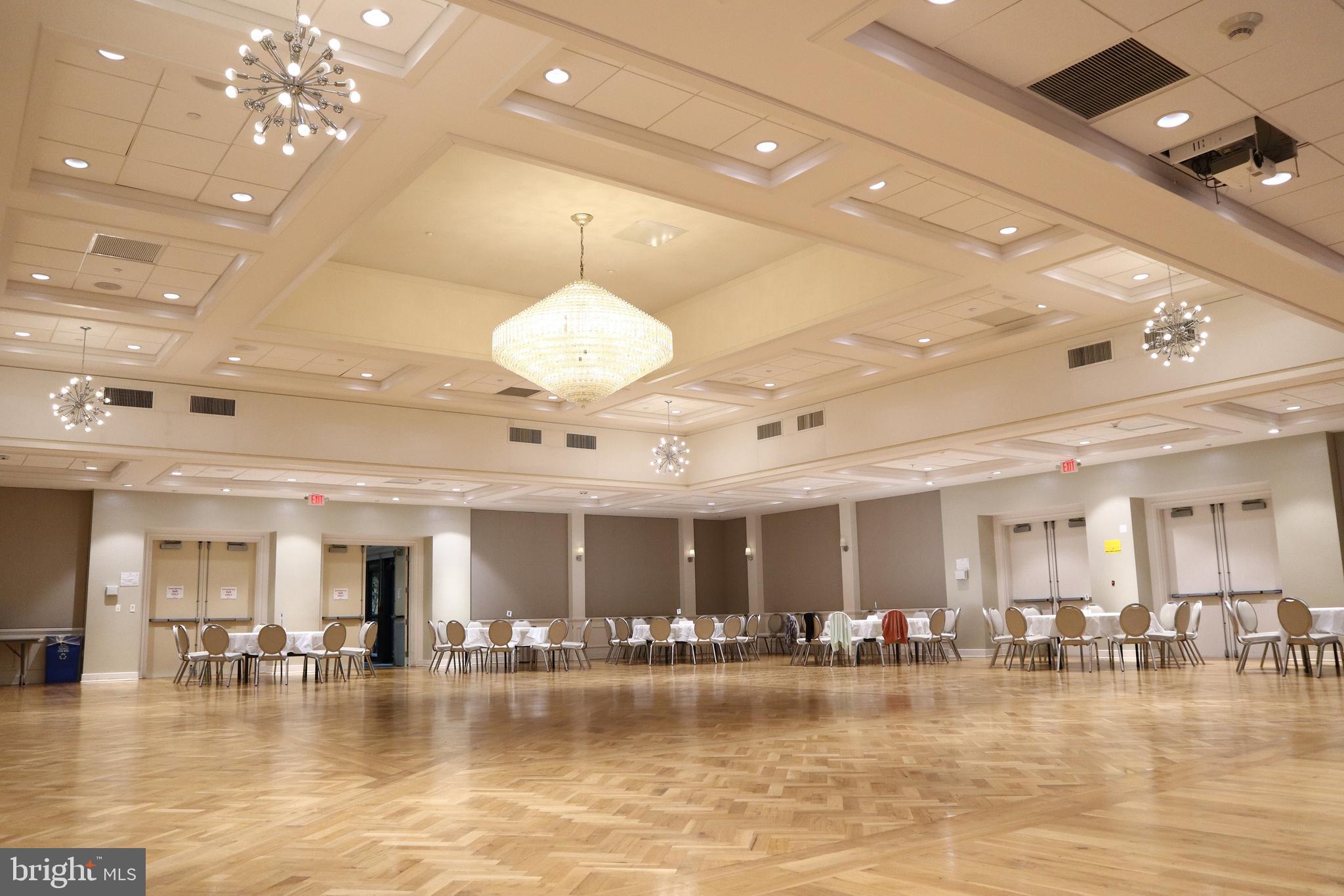 15107 Interlachen Drive, Unit 2119 Silver Spring, MD 20906 - Photo 29 of 53 a view of a room with lots of dining room and chandelier