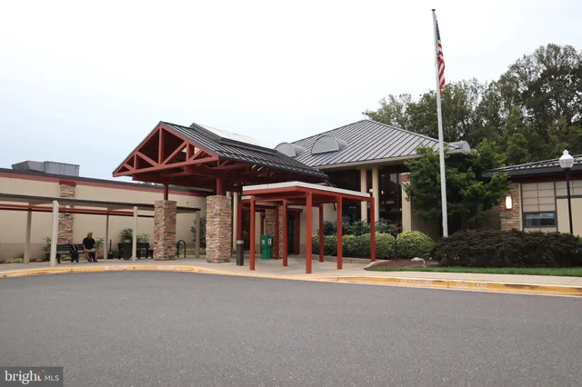 a kitchen with stainless steel appliances kitchen island granite countertop a stove a sink and a wooden cabinets