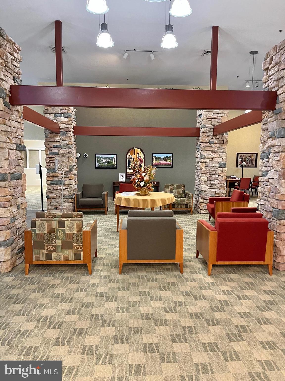 15107 Interlachen Drive, Unit 2119 Silver Spring, MD 20906 - Photo 37 of 53 a kitchen with stainless steel appliances kitchen island granite countertop a stove a sink and a wooden cabinets