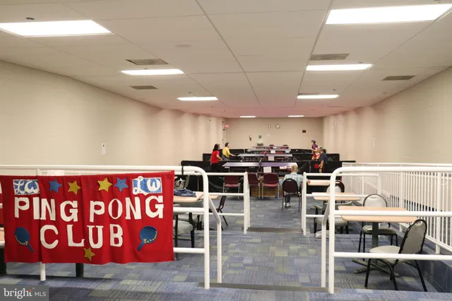 a dining room with furniture water view and a floor to ceiling window