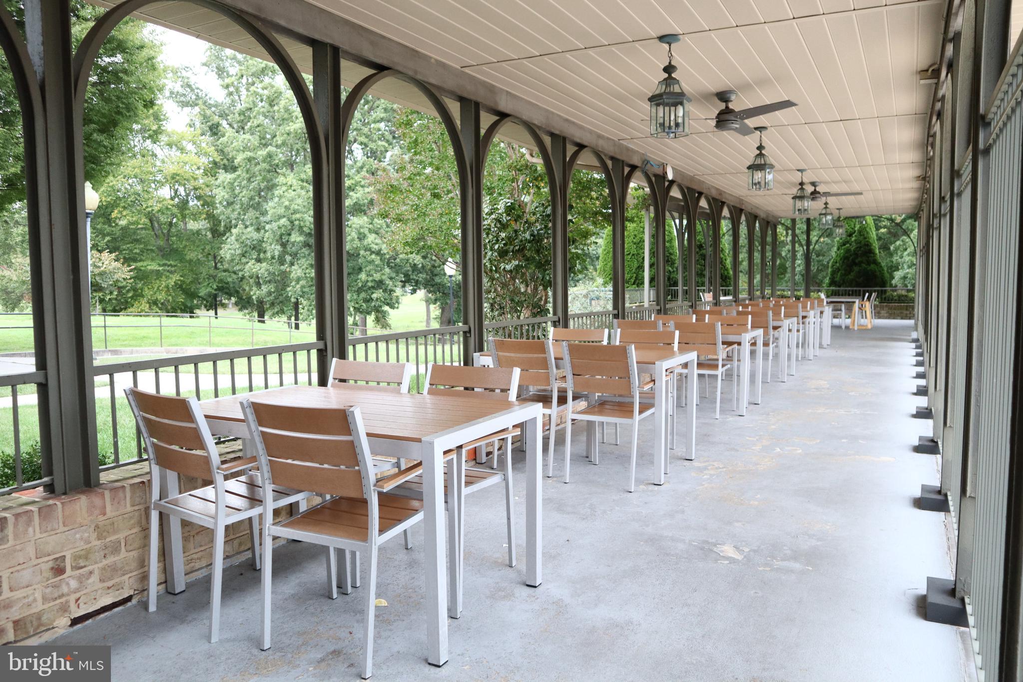 15107 Interlachen Drive, Unit 2119 Silver Spring, MD 20906 - Photo 45 of 53 a dining room with furniture water view and a floor to ceiling window