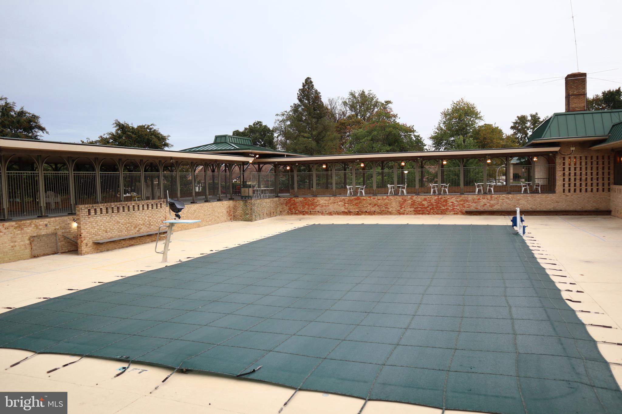 15107 Interlachen Drive, Unit 2119 Silver Spring, MD 20906 - Photo 46 of 53 a view of a swimming pool with a lounge chair