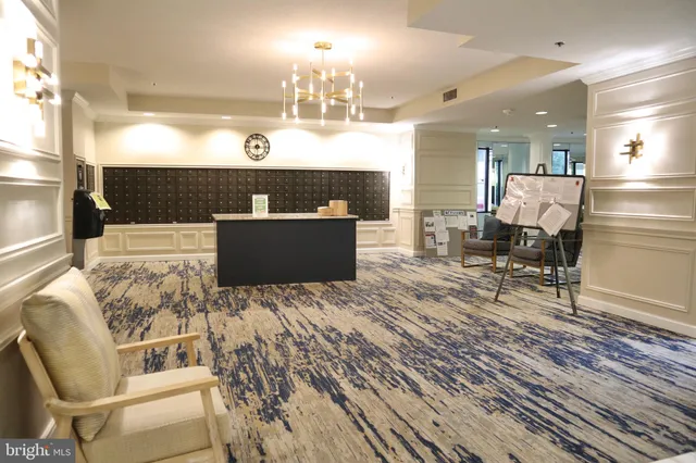 a living room with furniture a large window and chair