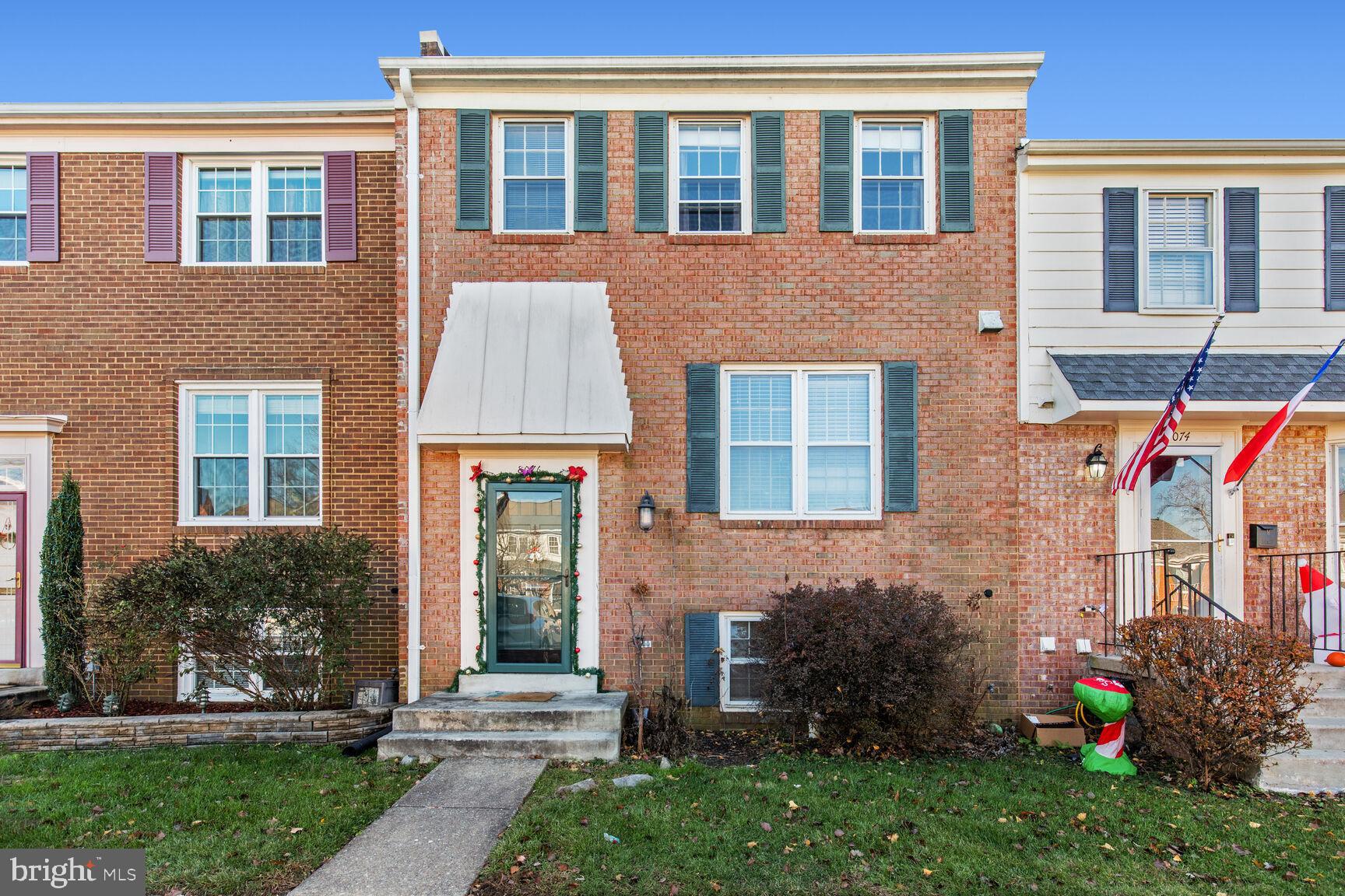 8076 Powderbrook Lane Springfield, VA 22153 - Photo 1 of 20 a front view of a house with garden