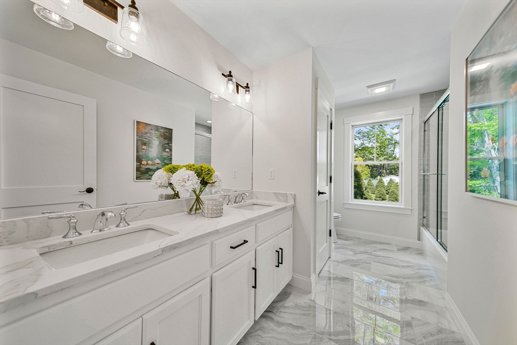 120 Lawton Road Needham, MA 02492 - Photo 19 of 34 a spacious bathroom with a granite countertop sink mirror and a