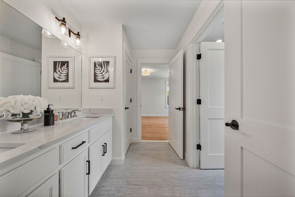 120 Lawton Road Needham, MA 02492 - Photo 23 of 34 a spacious bathroom with a double vanity sink a mirror a shower and a bathtub
