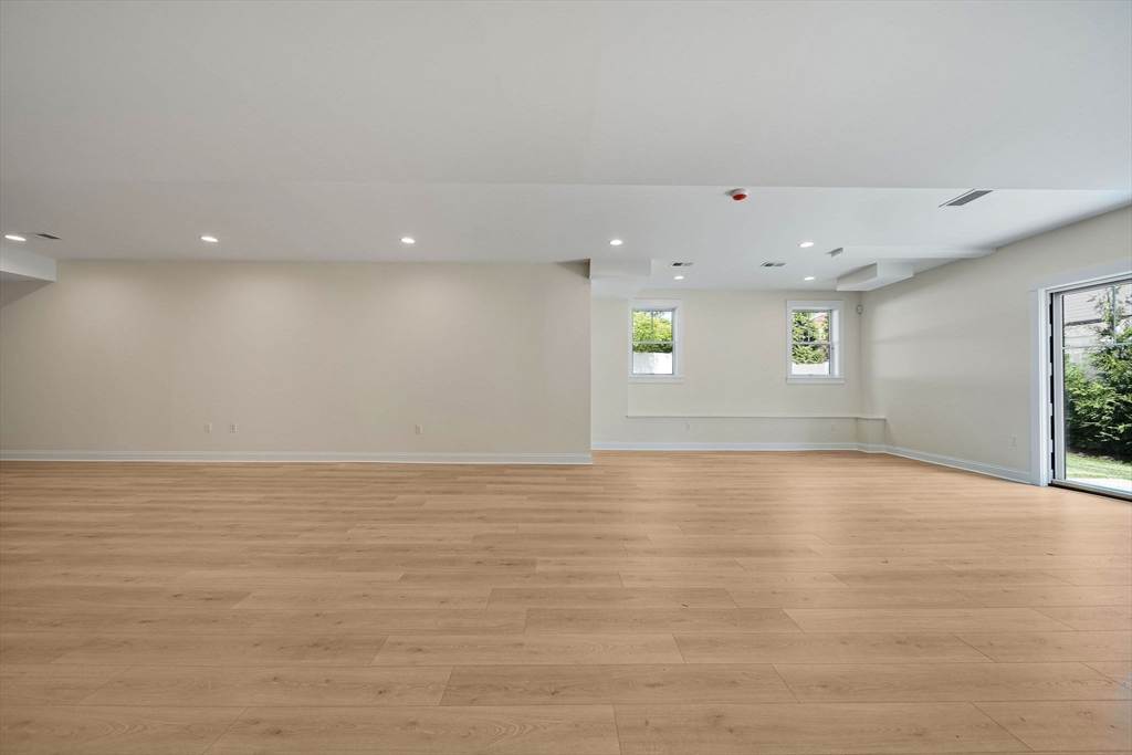 120 Lawton Road Needham, MA 02492 - Photo 28 of 34 a view of an empty room with wooden floor and a window
