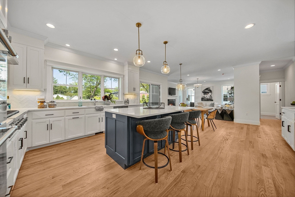 120 Lawton Road Needham, MA 02492 - Photo 4 of 34 a kitchen with a table chairs wooden floors and a view of living room