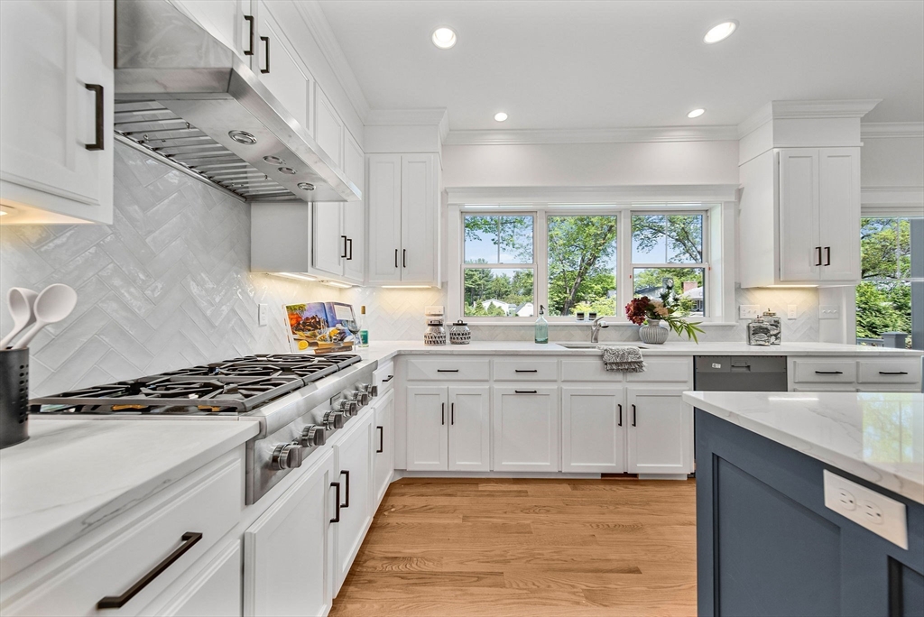 120 Lawton Road Needham, MA 02492 - Photo 6 of 34 a kitchen with stainless steel appliances granite countertop a stove a sink and a microwave